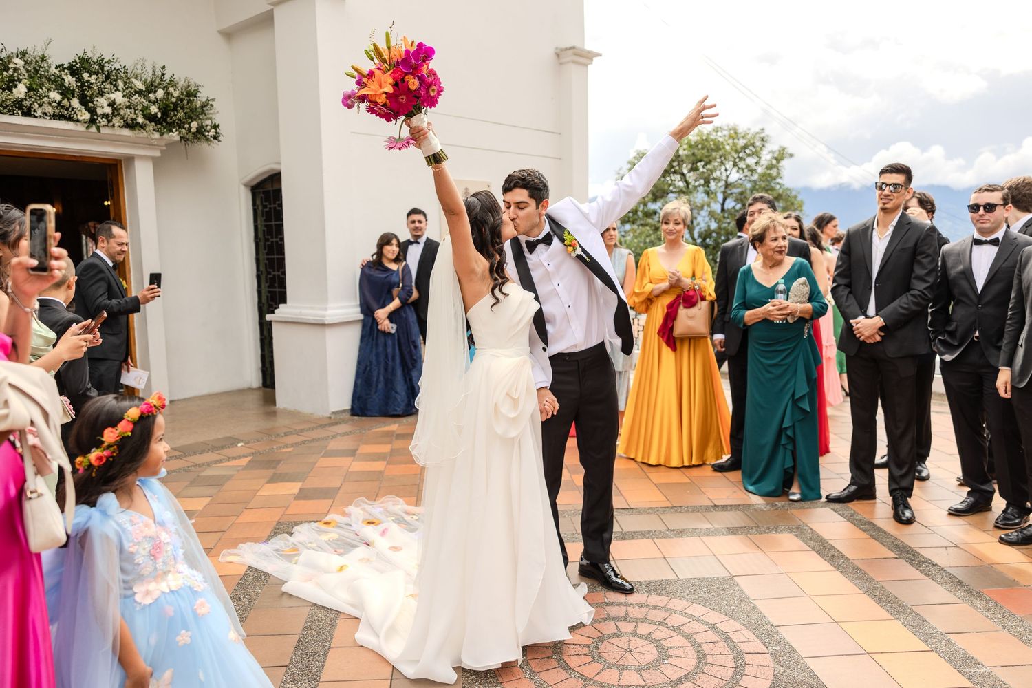 Wedding celebration at an elegant venue with guests dancing and celebrating.