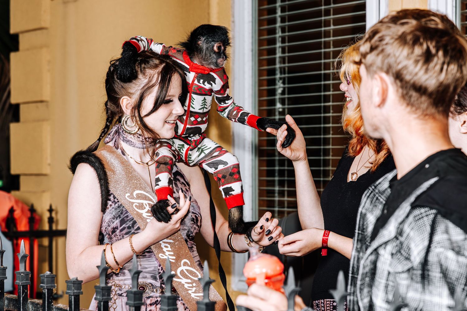People gather in a lively social setting with drinks and conversations at what appears to be a bar or party venue.