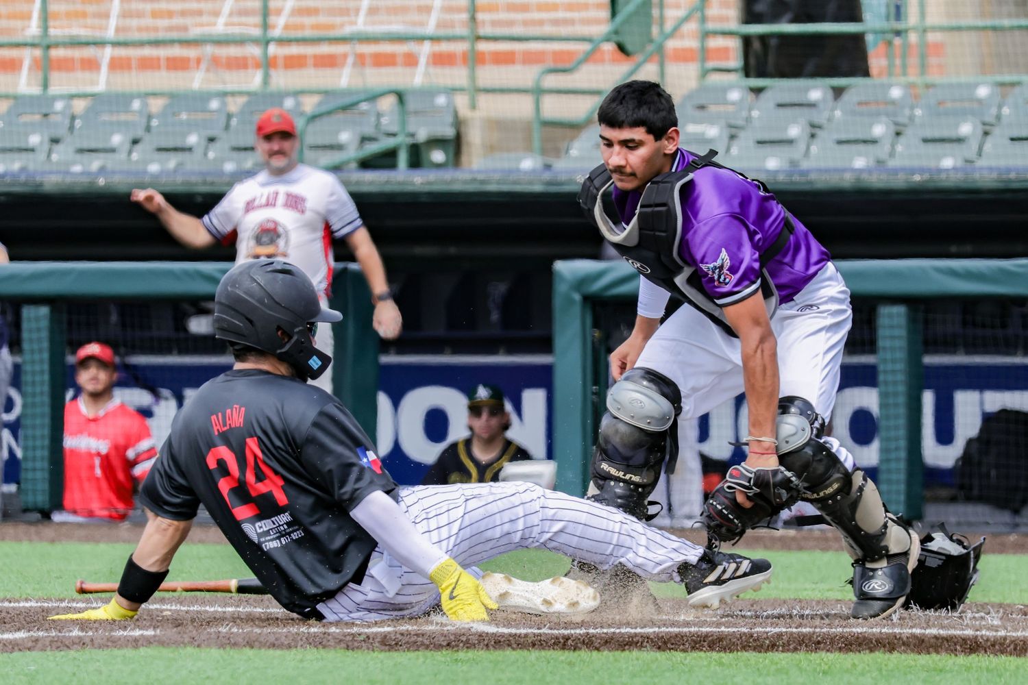 Baseball players dive and slide across the field during an intense game sequence.