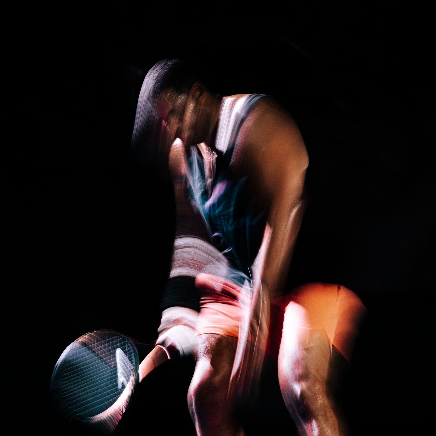 Abstract motion blur photography captures dancer in performance creating dynamic streaks of light and movement.