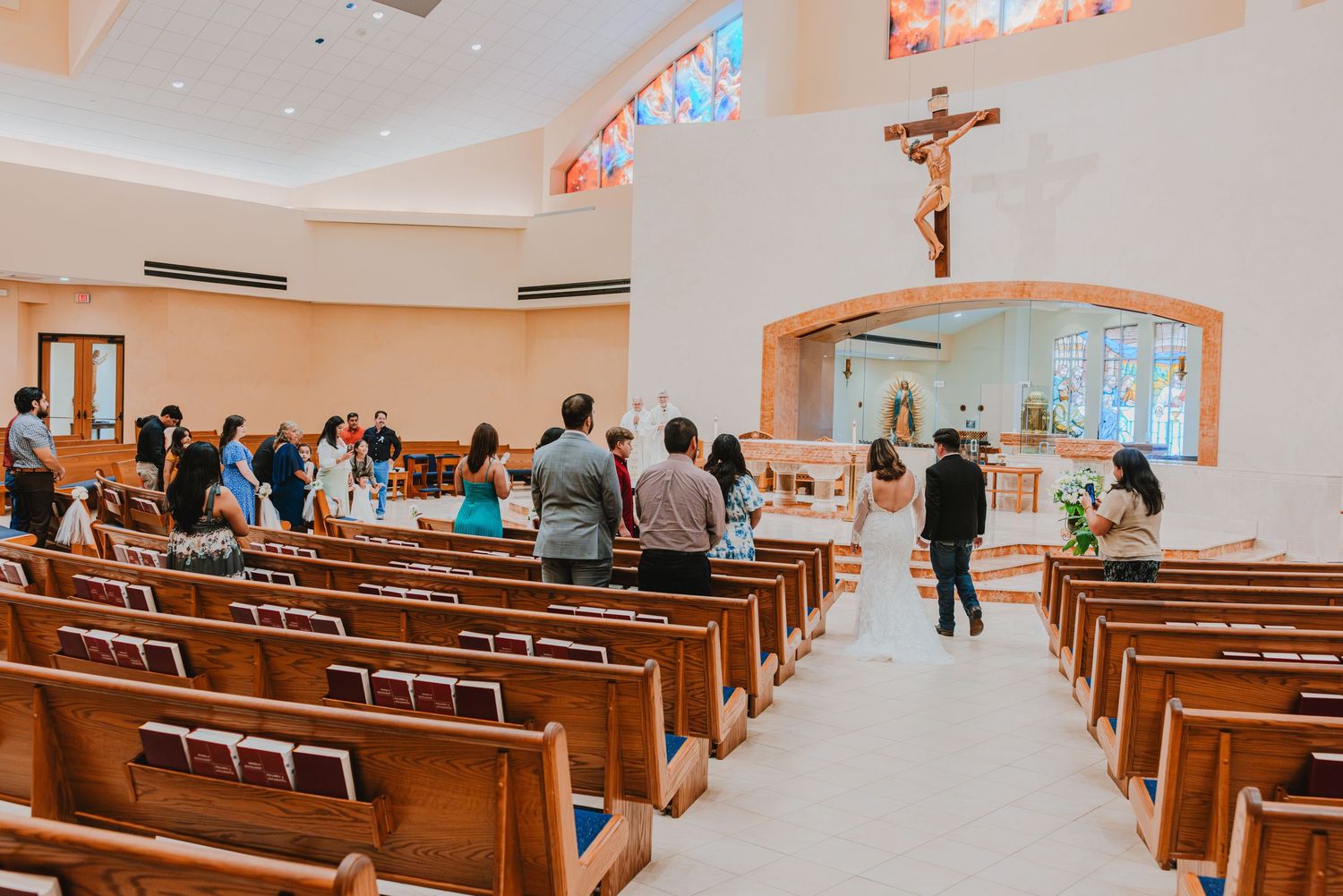 Panoramic view of a church interior with wooden pews and warm lighting creating a peaceful atmosphere.