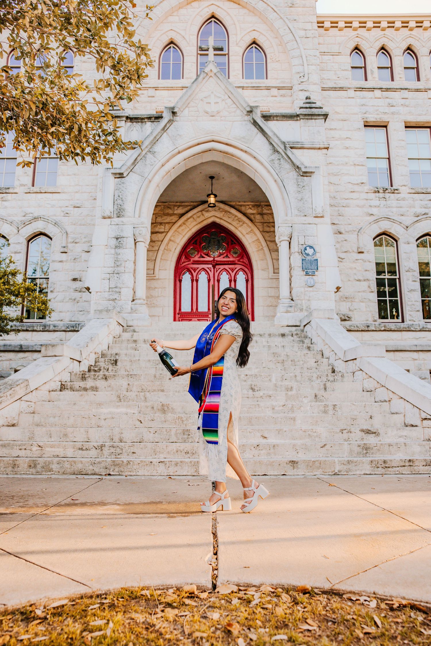 A series of four photos showing a dancer performing graceful poses in front of a gothic stone church entrance.
