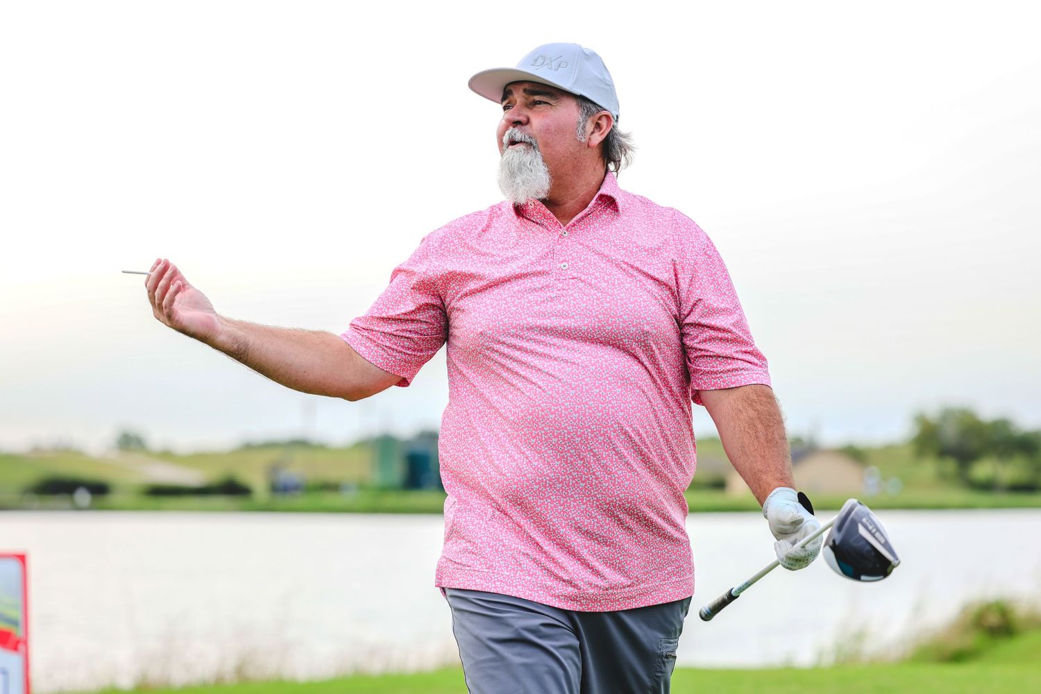 A golfer in a pink polo shirt demonstrates a golf swing sequence from setup to follow through on a sunny day.