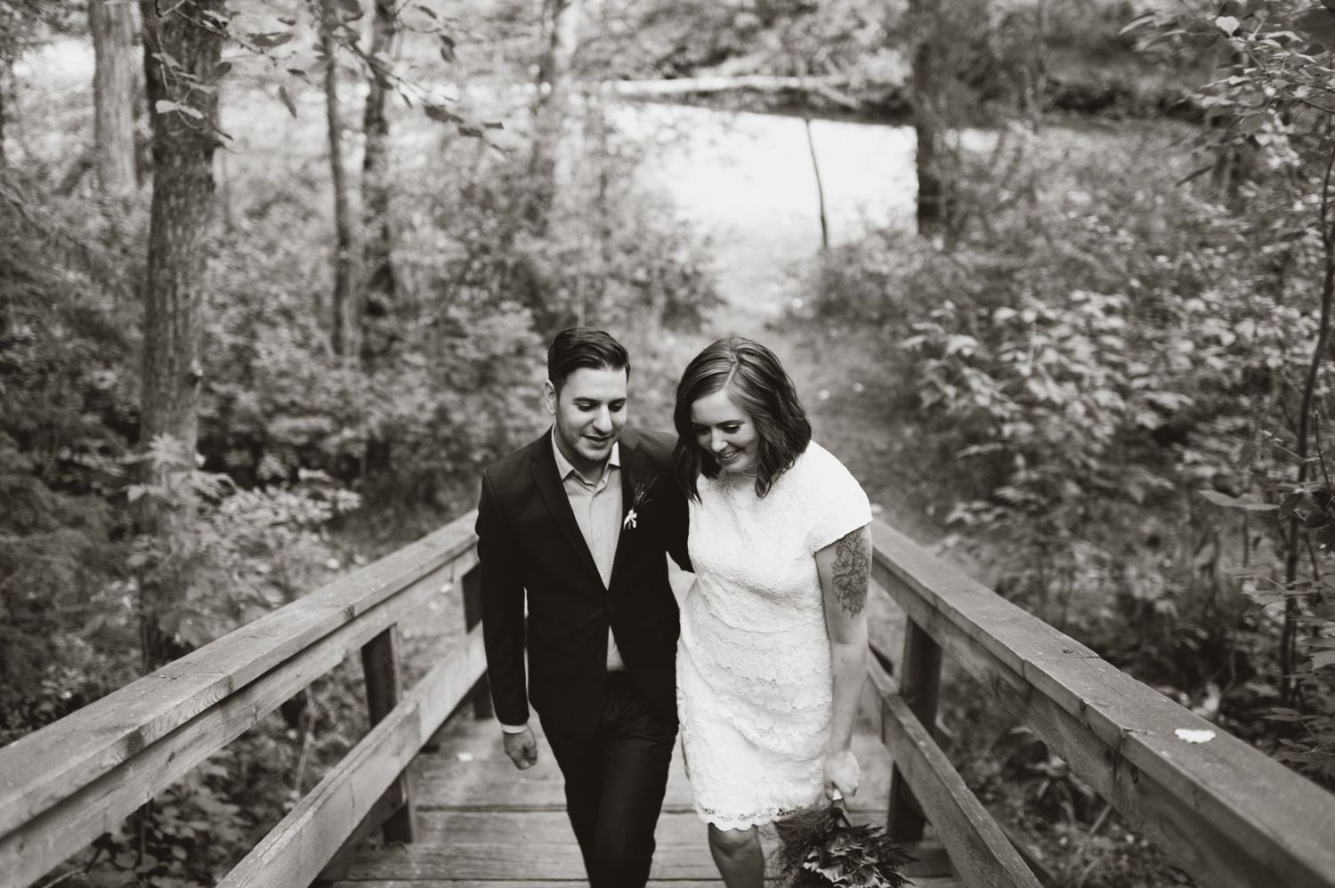 Laughing couple in forest during wedding day stroll. Edmonton or Calgary elopement with rustic, editorial vibes.