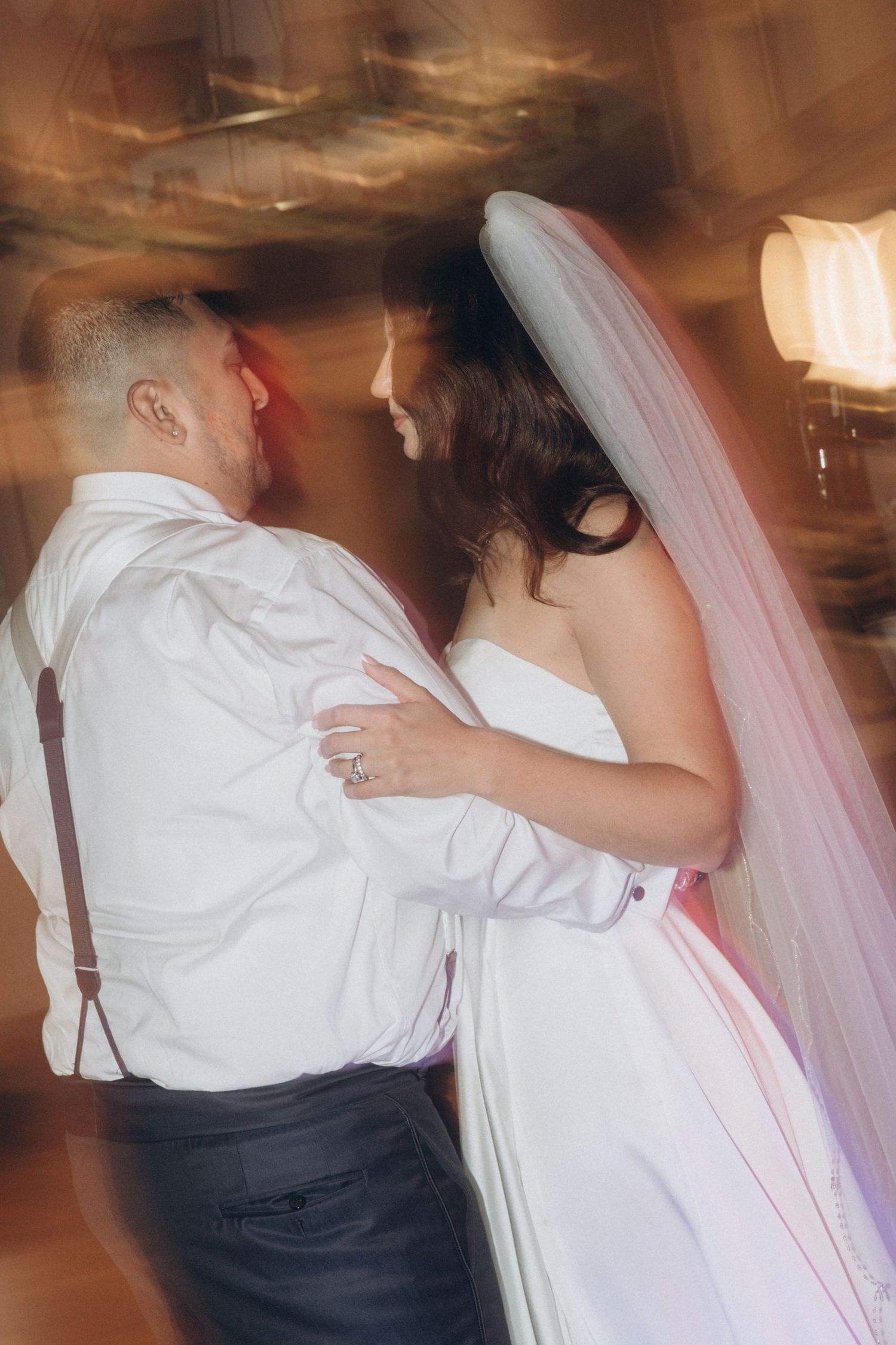 Romantic dance moment captured in motion blur at wedding reception.