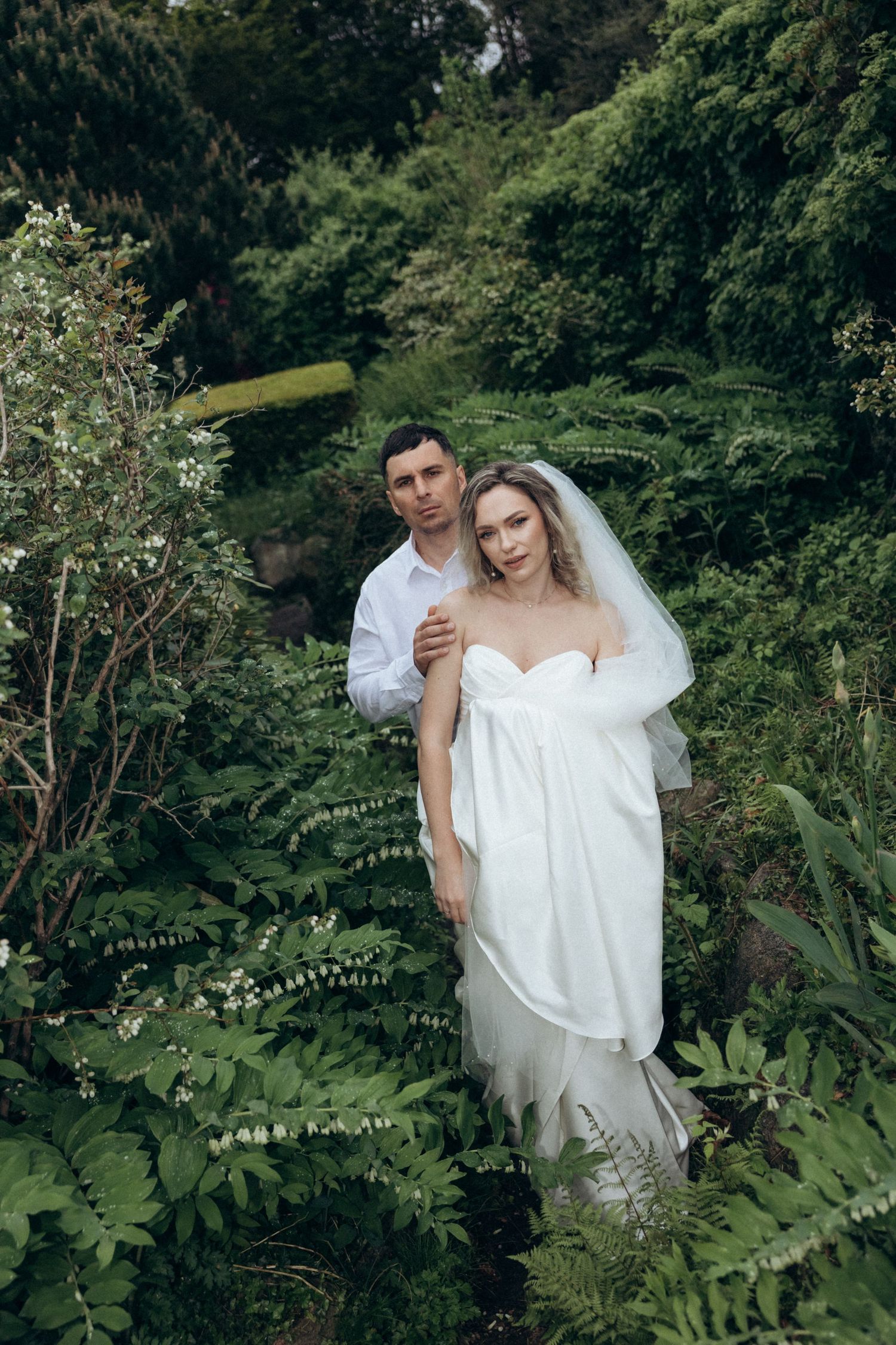 Romantic wedding portraits taken among lush green tropical foliage.