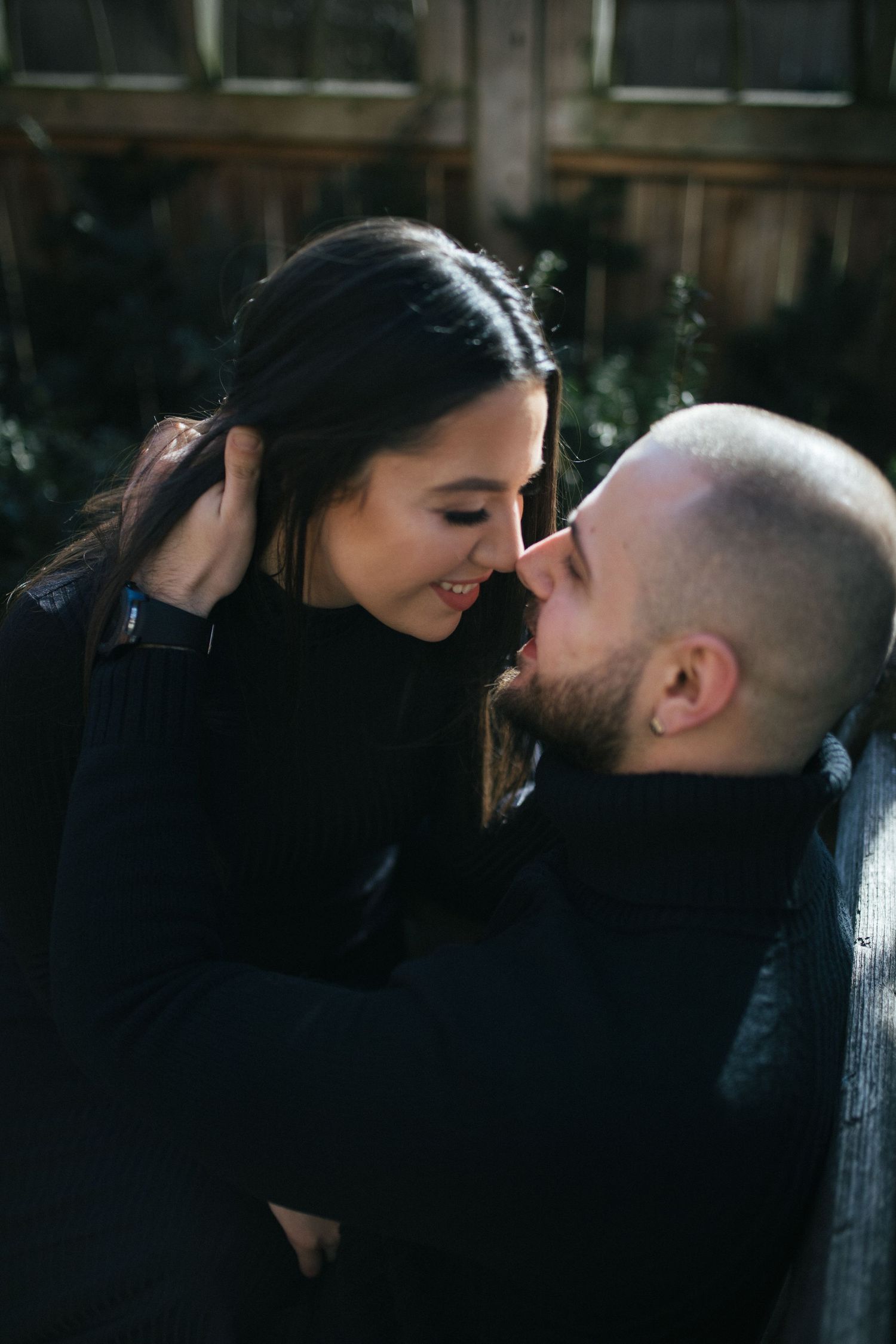 Intimate black and white couple portraits against a dark background.