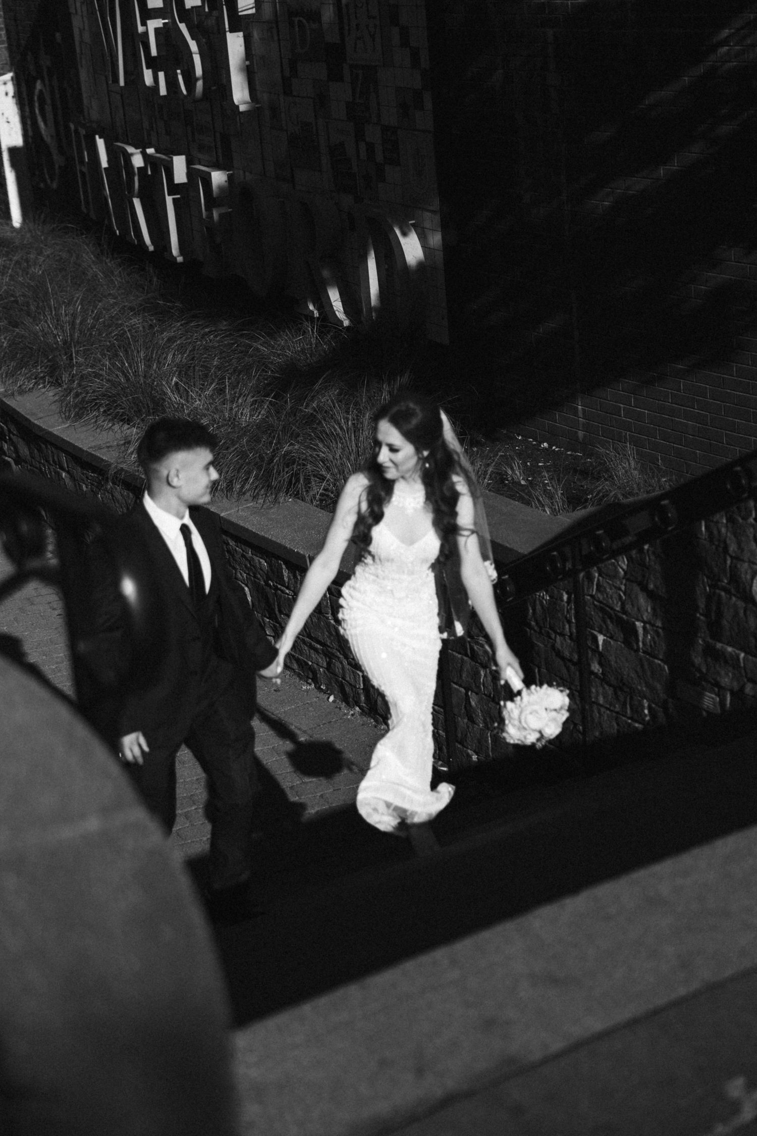 Black and white nighttime wedding photography with string lights.