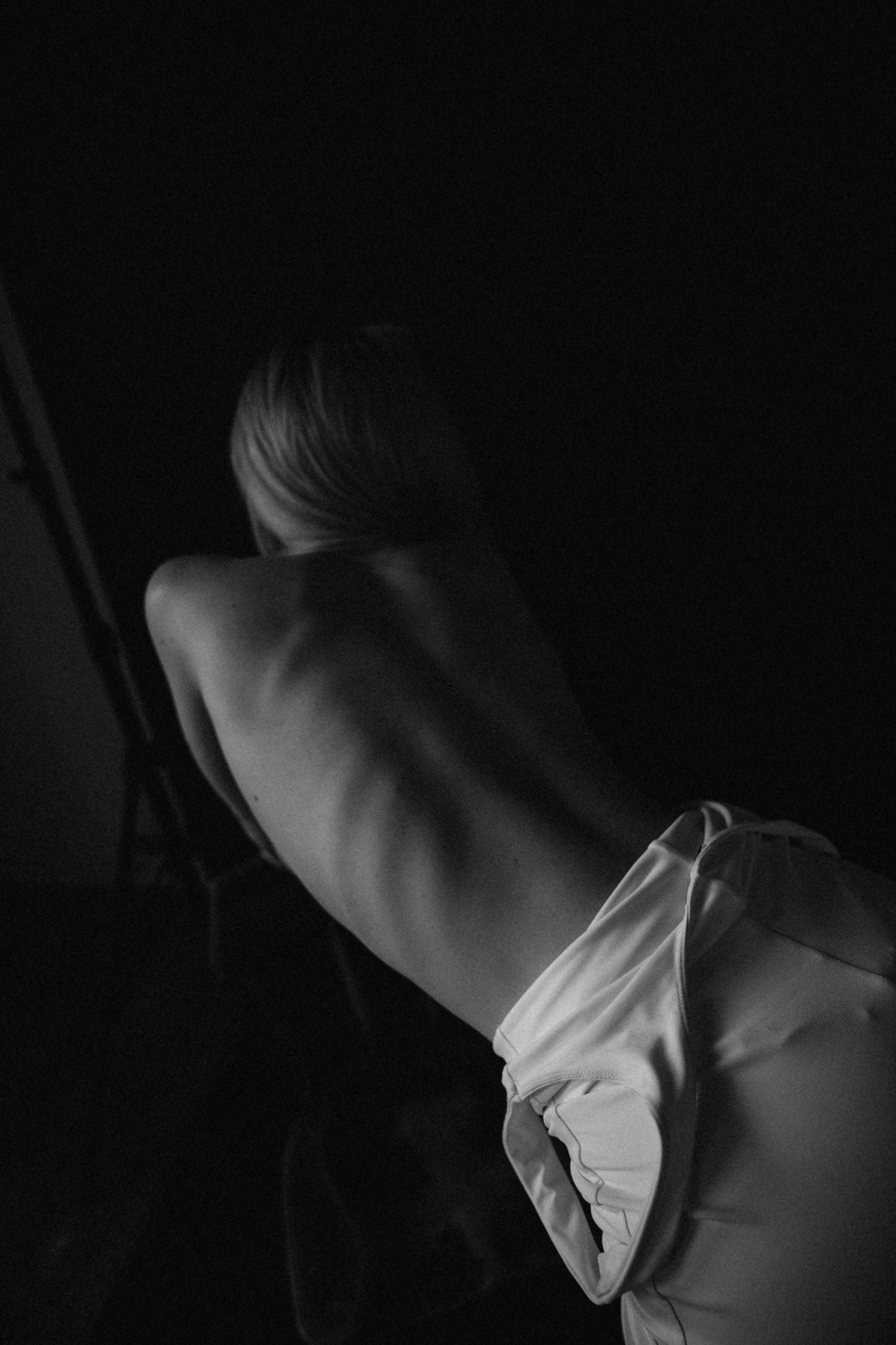 Moody black and white close-up shots focusing on neck and shoulder details.