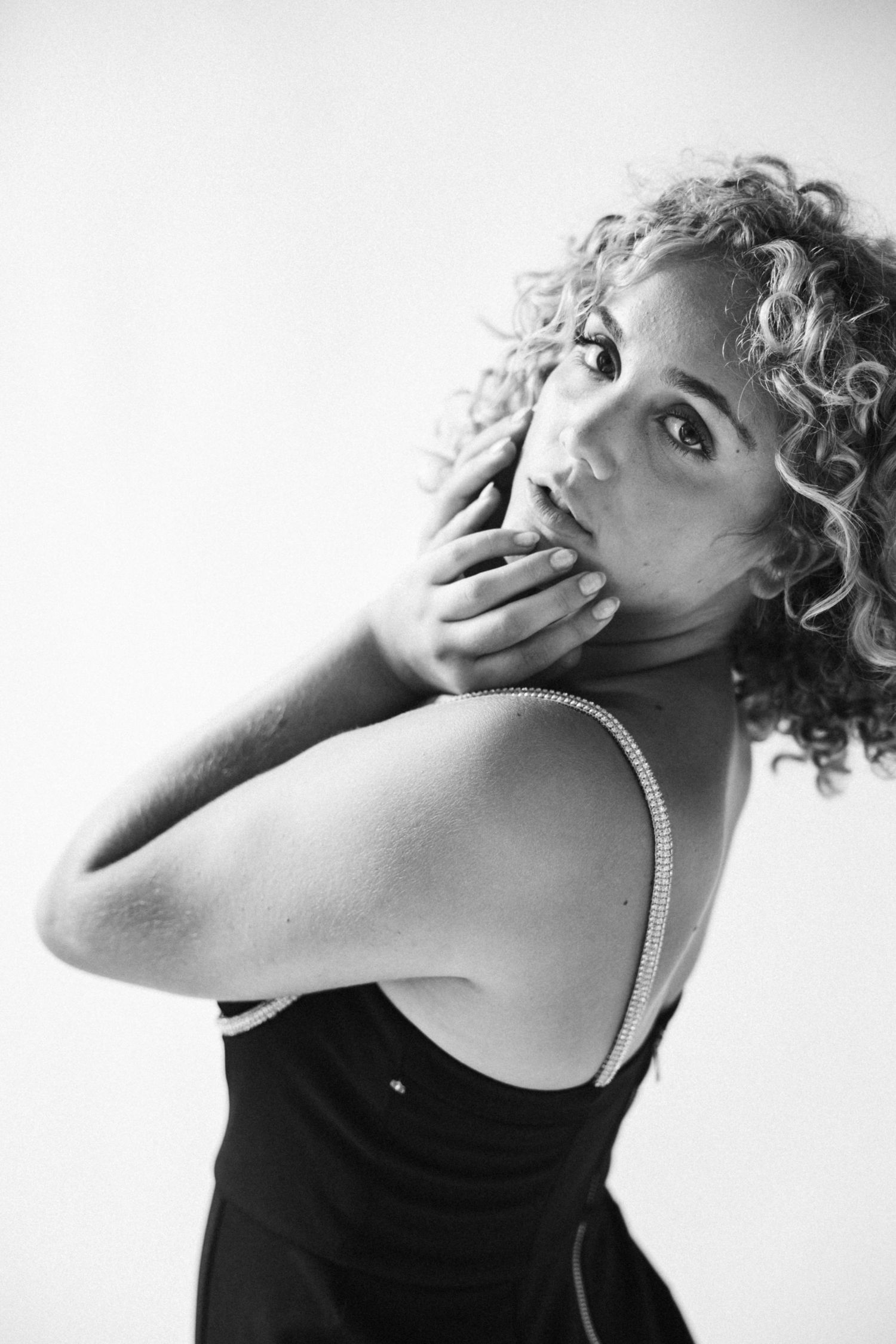 Emotive portrait sequence in black and white with dramatic hand gestures.