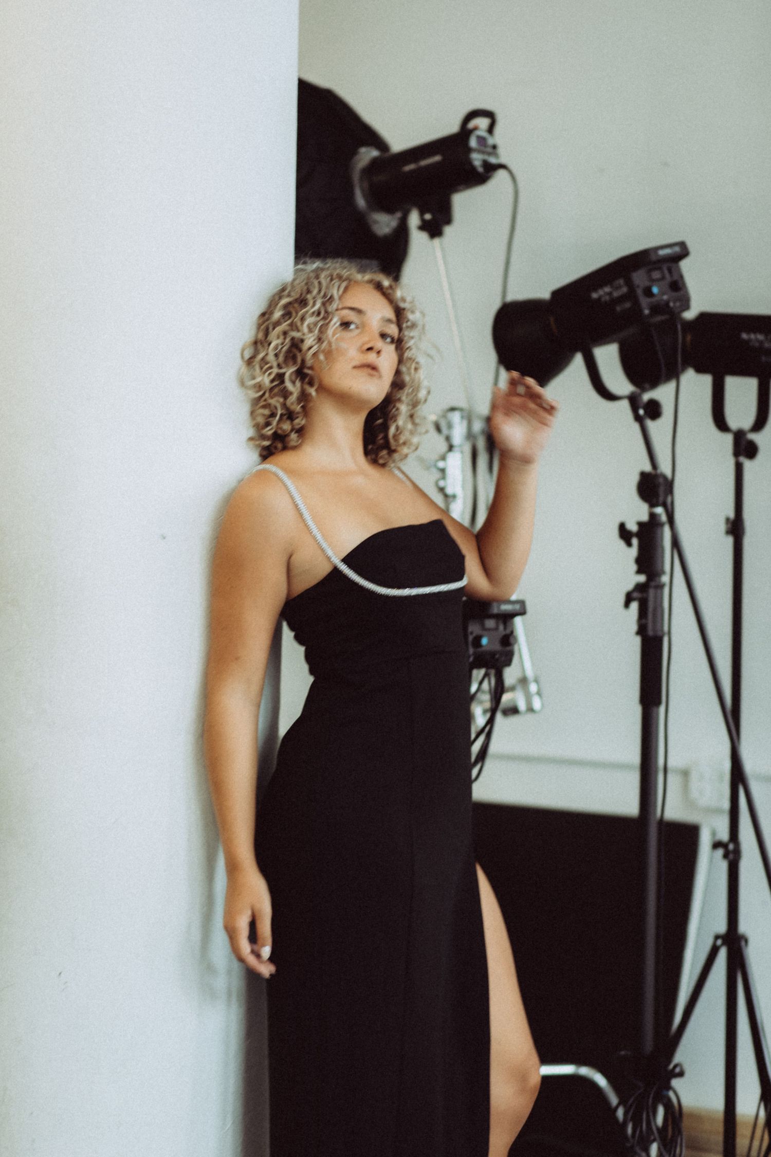 Behind the scenes photo shoot with studio lighting and black evening wear.