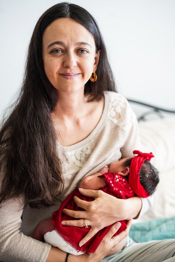 A photo of a mother breastfeeding her little baby.