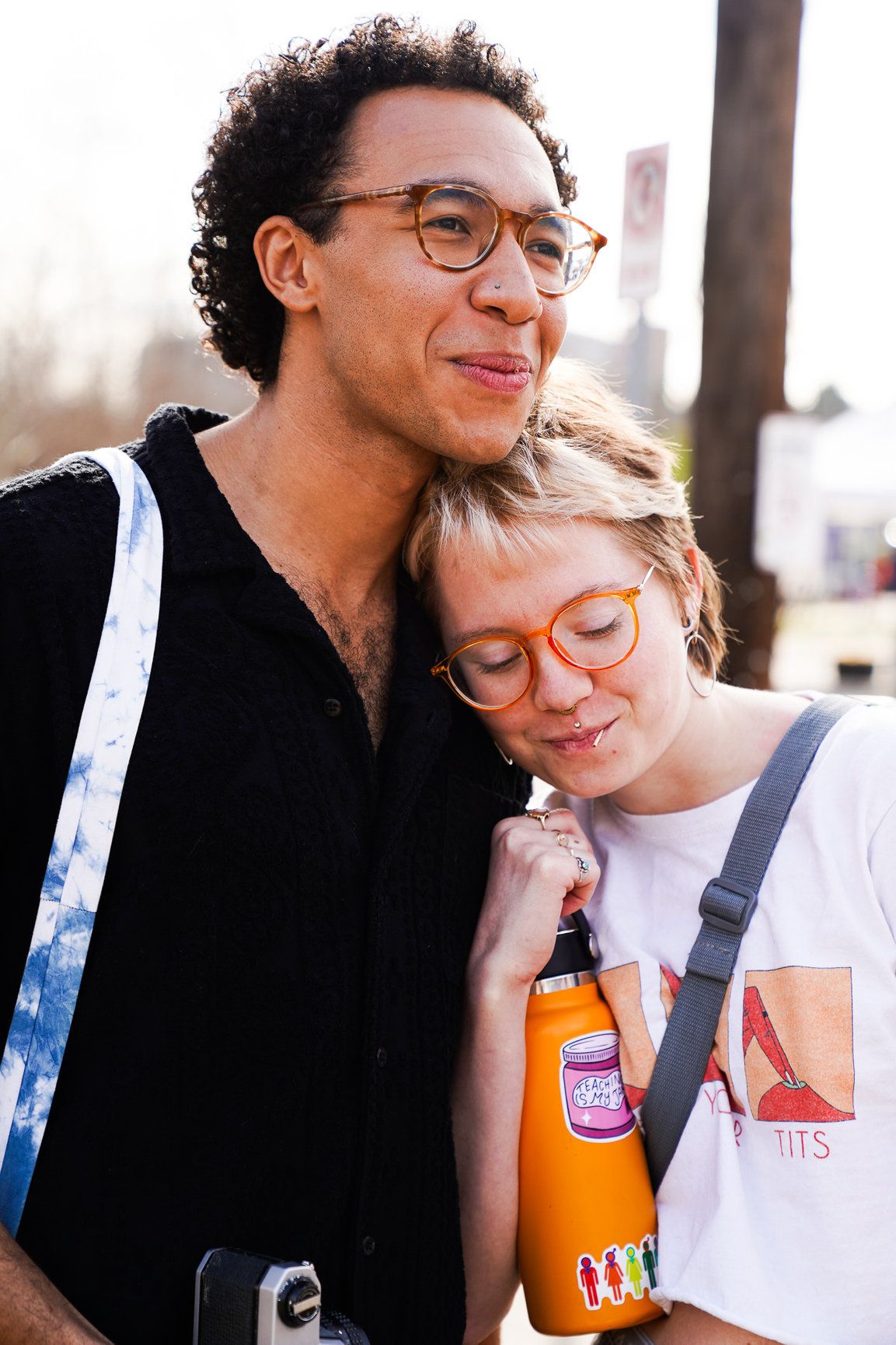 A woman hugs a man as they watch a live band perform in downtown Boulder, enjoying the music and relaxed atmosphere of the city.