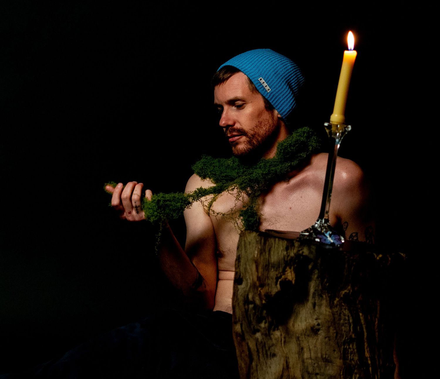 A series of moody candlelit portraits showing someone in dark clothing against a shadowy background with dramatic lighting.