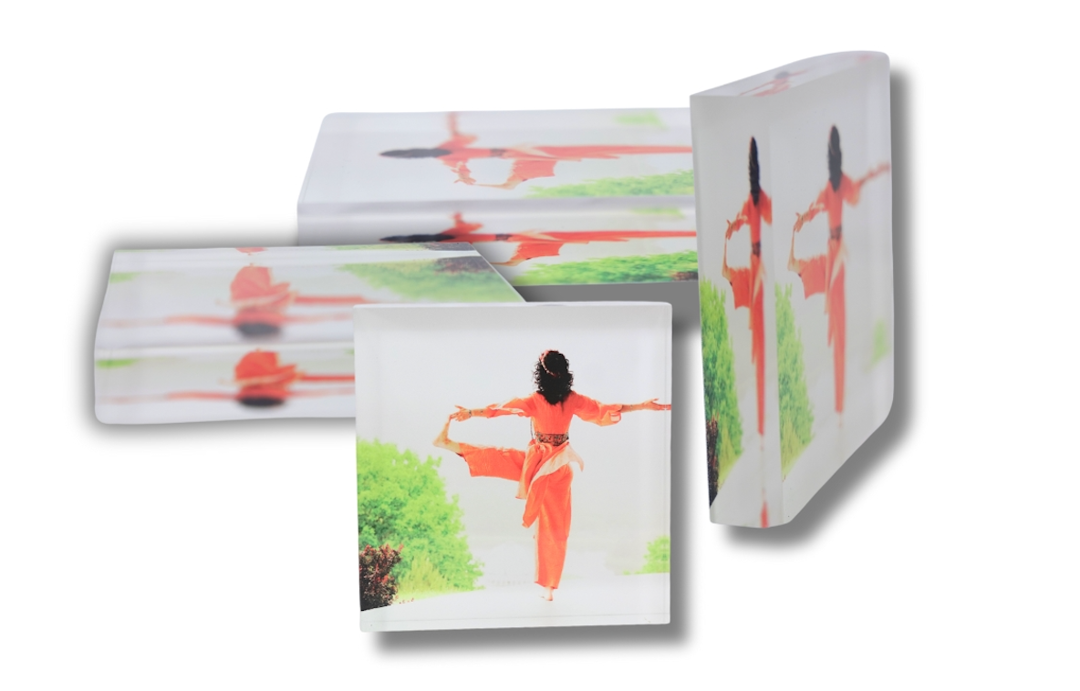 A row of white wall-mounted mailboxes with orange and green decorative dragonfly designs on them.