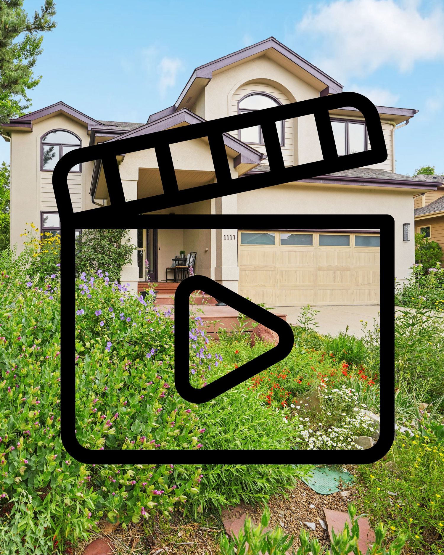 Video tour of a two-story beige stucco home with a two-car garage surrounded by lush colorful garden landscaping.