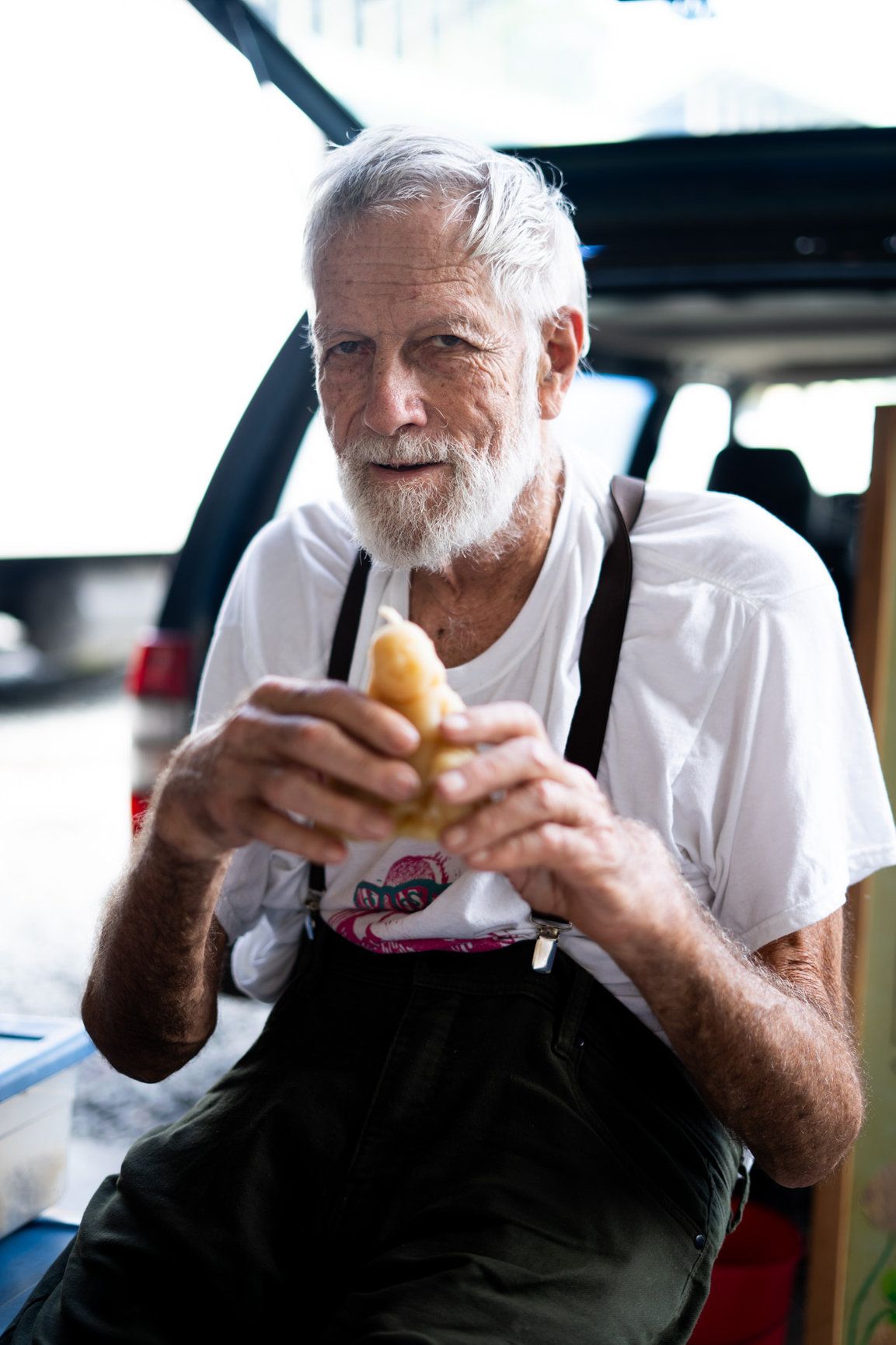 A cute picture of an old man holding a little buddha candle