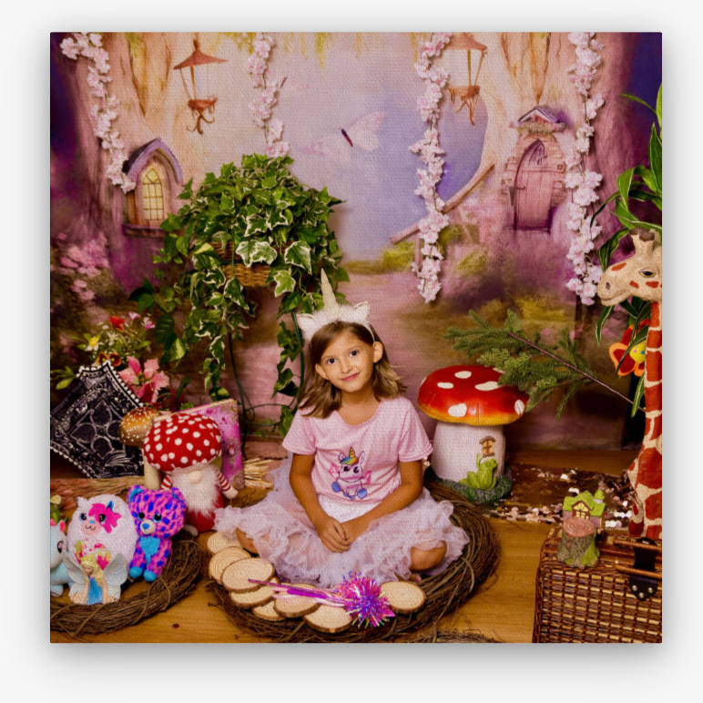 A photo of a woman looking at the camera in a fairytale scene with fake mushrooms around her.