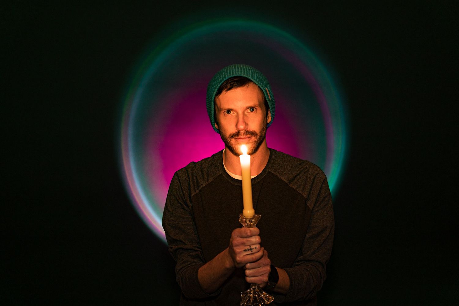 A sequence of dark photos shows a person lighting a match, creating a glowing orange flame against a black background.