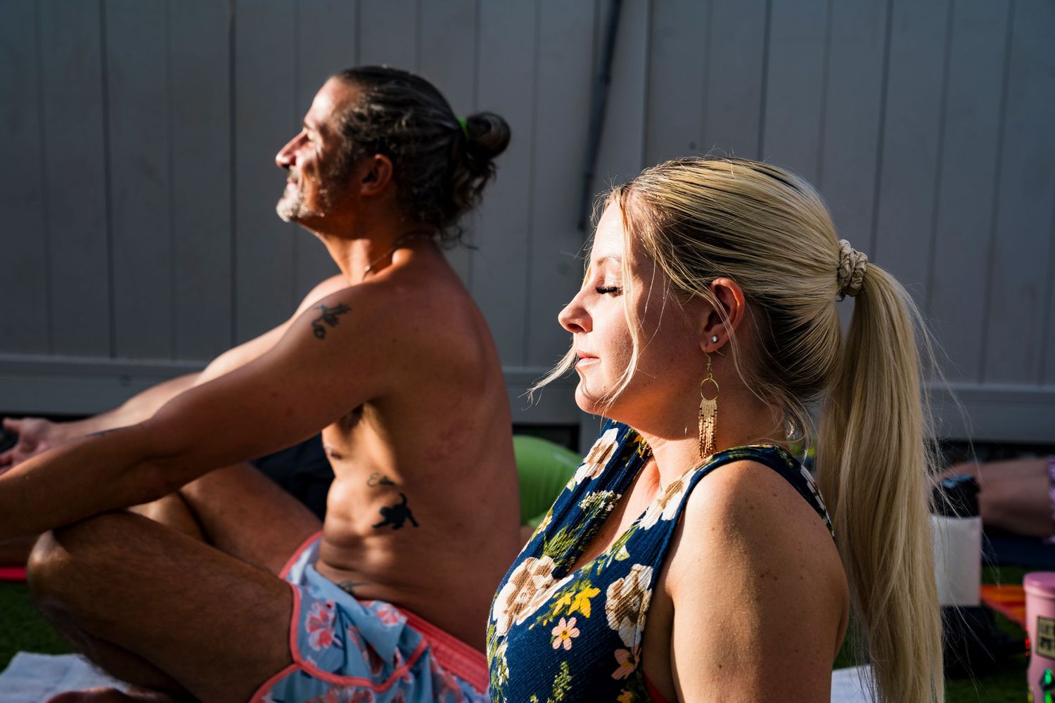 A photo of people with their eyes closed on their yoga mats at a yoga event
