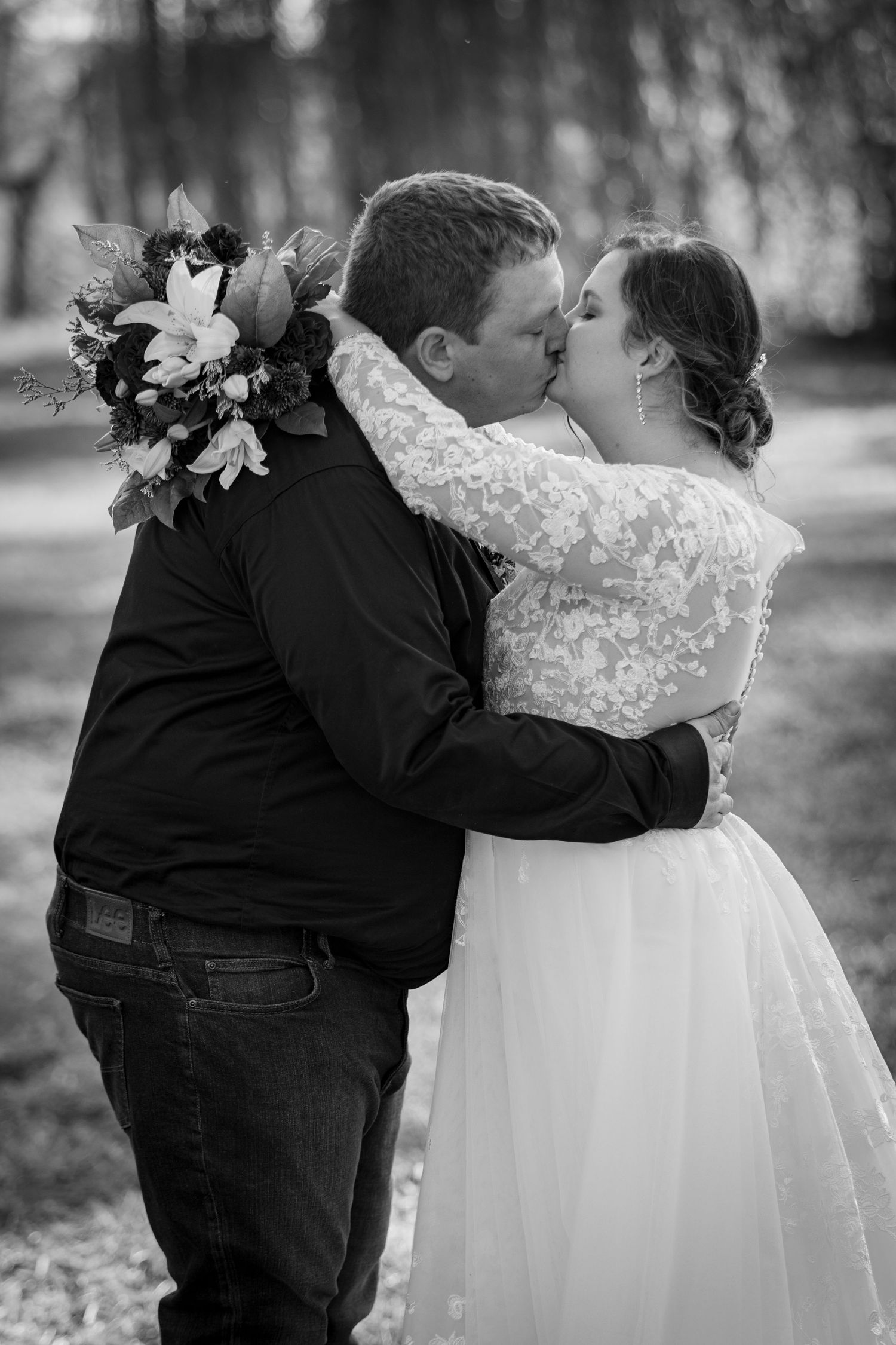 A series of black and white wedding photos showing a couple dancing together in formal attire.