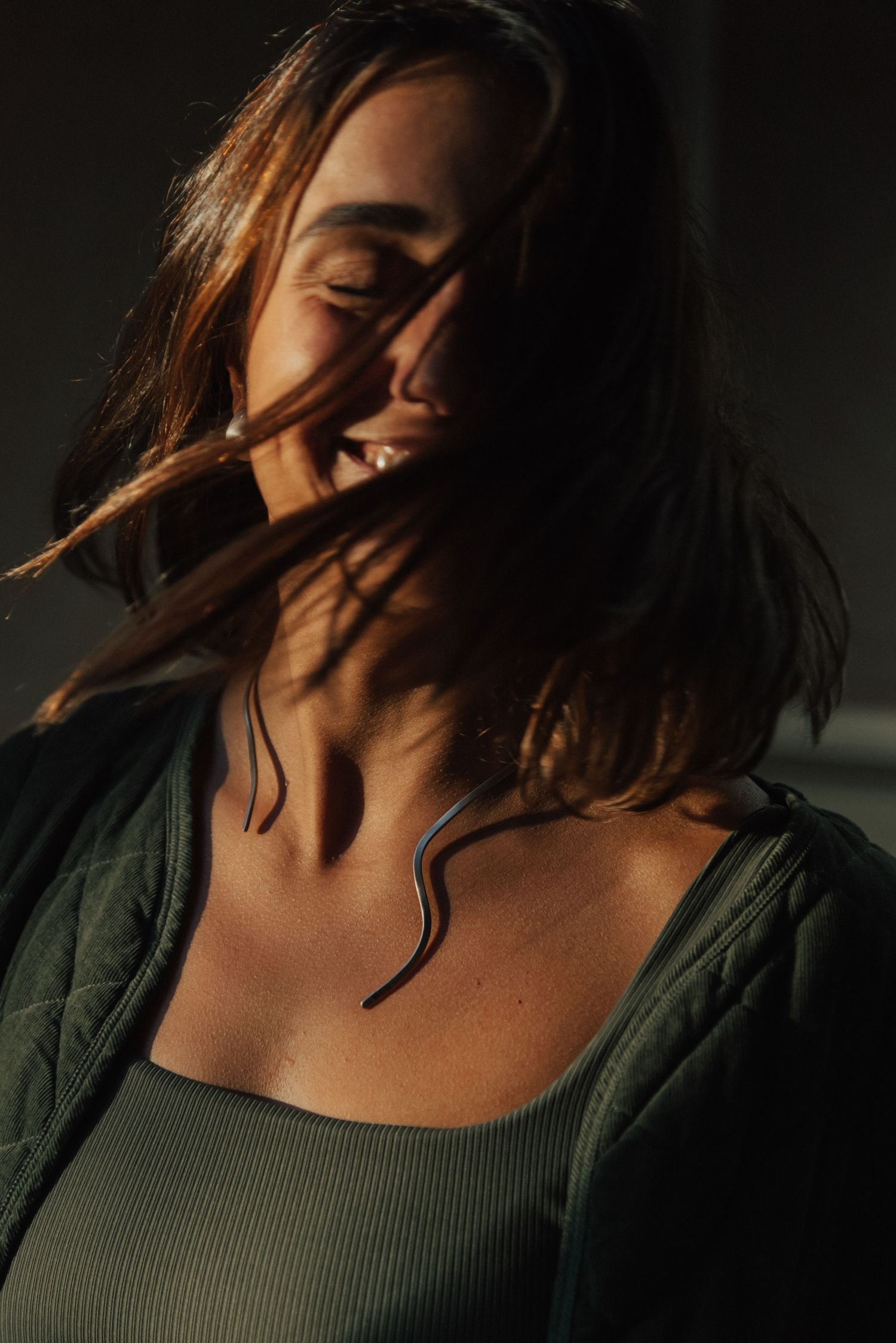A series of moody portraits showing a person's head tilted back against a dark background.