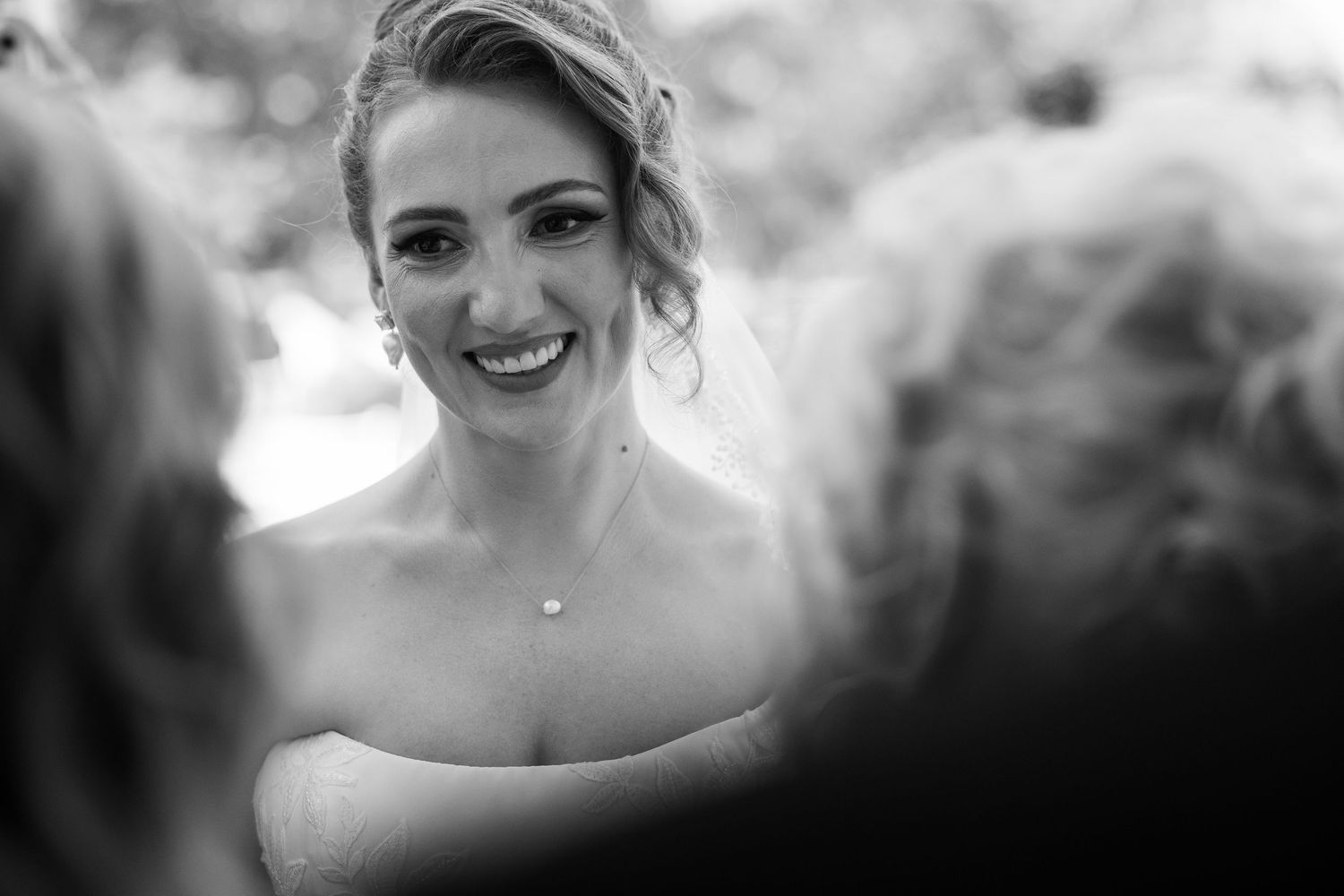 A series of black and white wedding photos showing romantic moments between a couple on their special day.