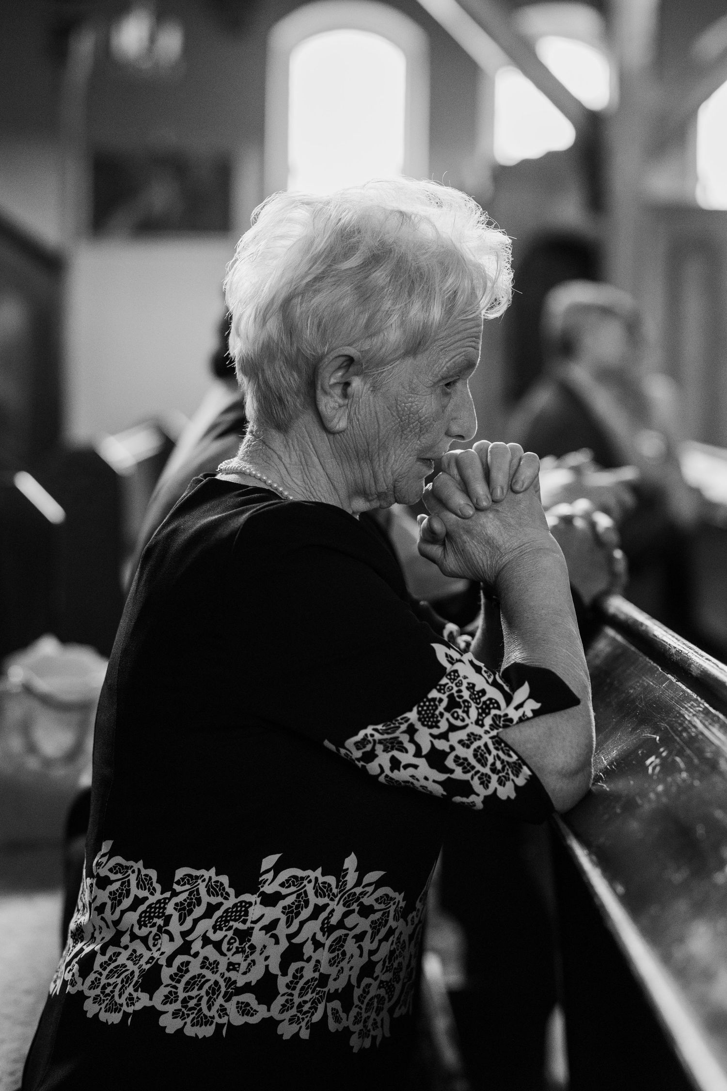 A series of black and white photos showing an elderly person in a patterned sweater resting their head on their hand.