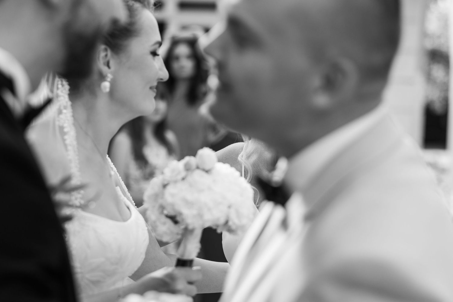 A collage of candid black and white wedding photos showing couples dancing and celebrating at a reception.