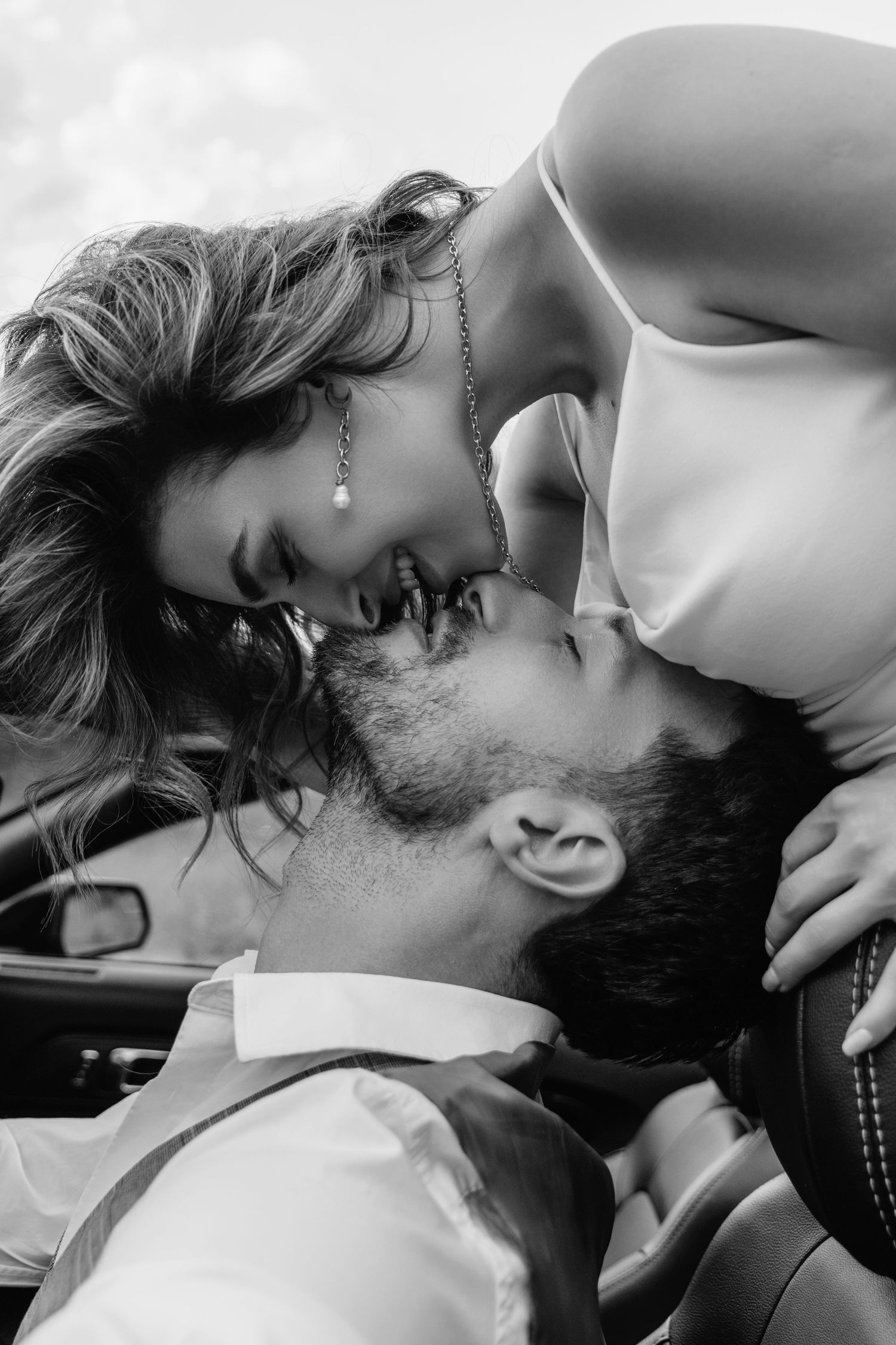 Intimate black and white portrait of couple sharing romantic moment.