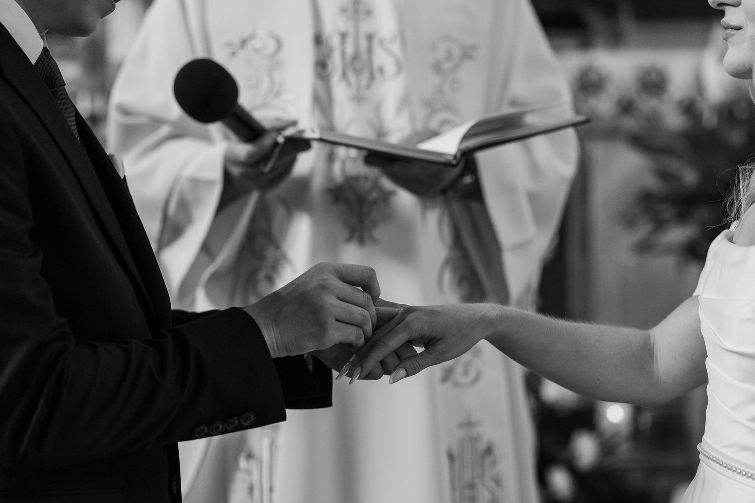 A series of black and white photos showing hands exchanging rings during a wedding ceremony.