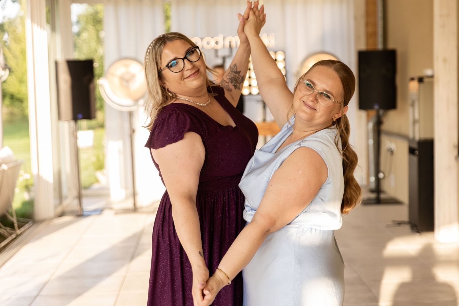 Two people in formal attire share a joyful dance moment together during a celebration.