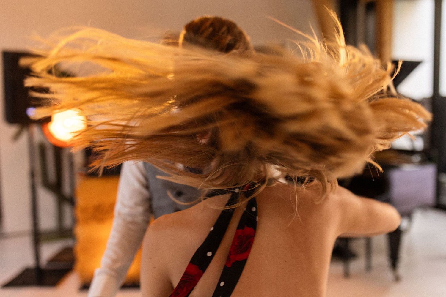 Seven dynamic action shots of long blonde hair being tossed and flipped in dramatic lighting.