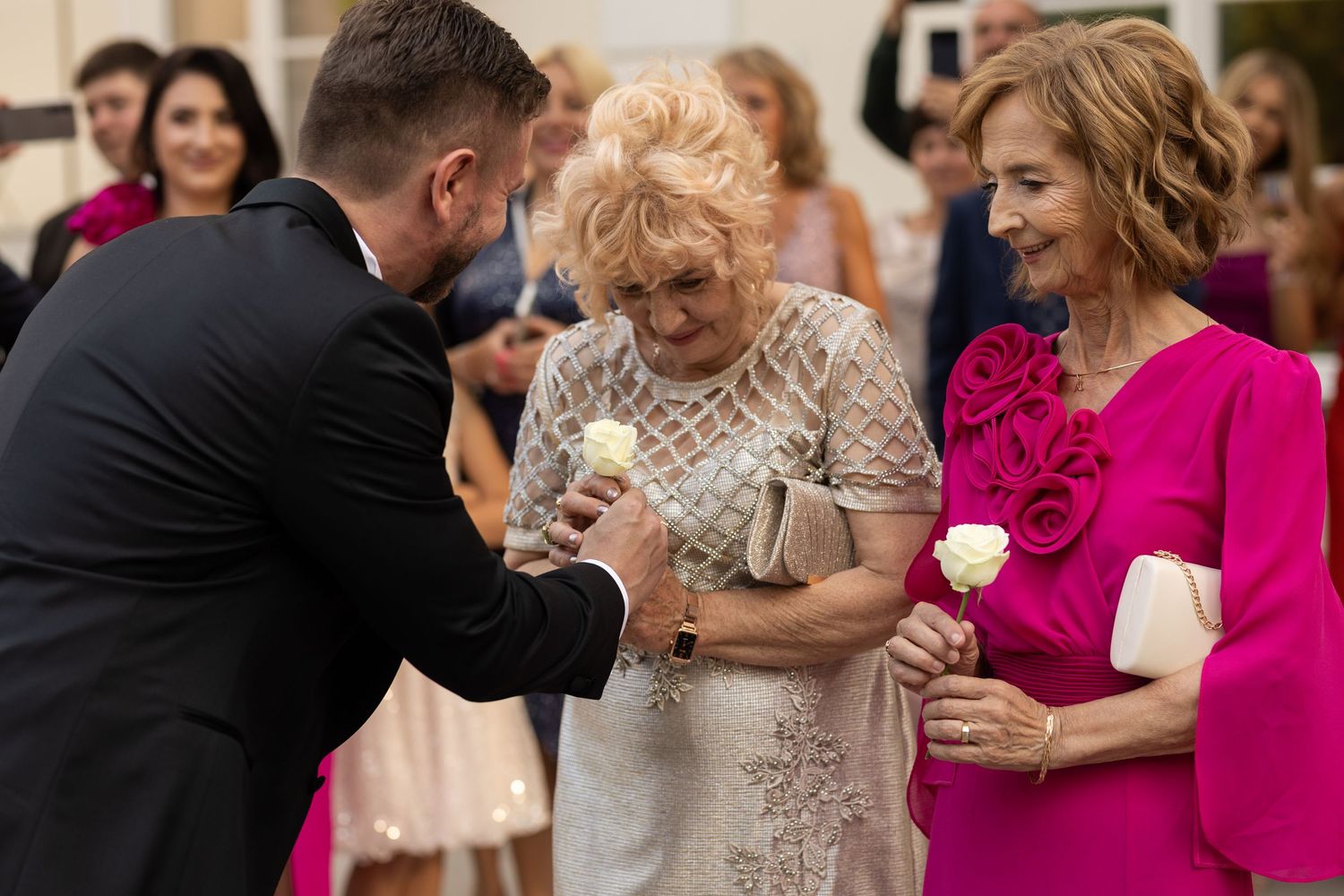 Wedding guests enjoy dancing and celebrating together at a lively reception party.