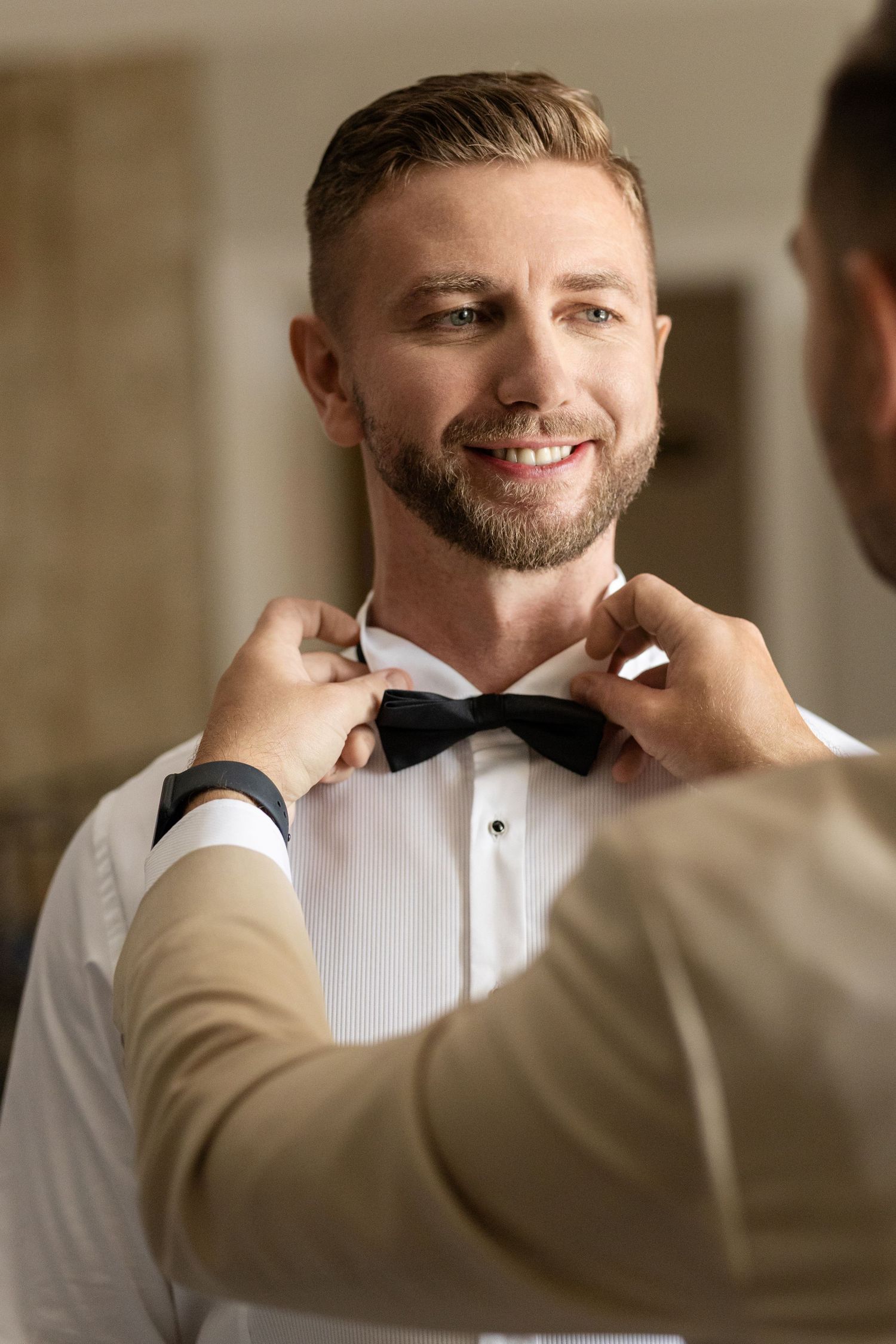 A series of candid wedding preparation photos showing joyful moments and genuine smiles in warm lighting.