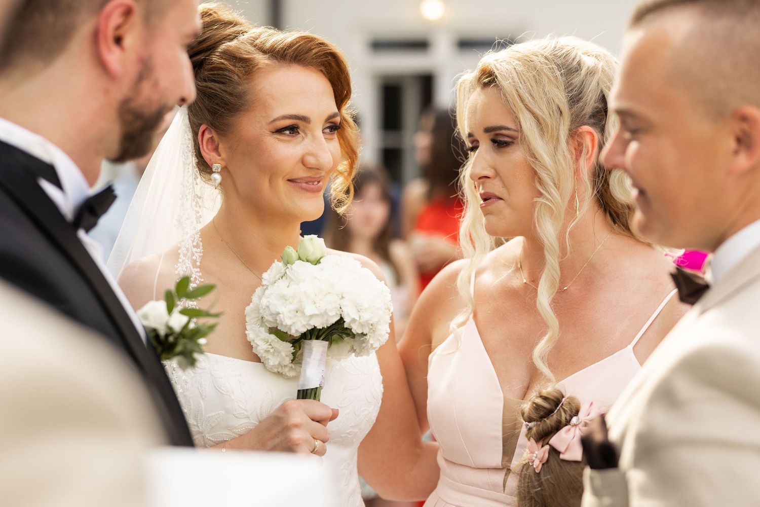 A collage of candid wedding moments showing joyful interactions between people during an outdoor celebration.