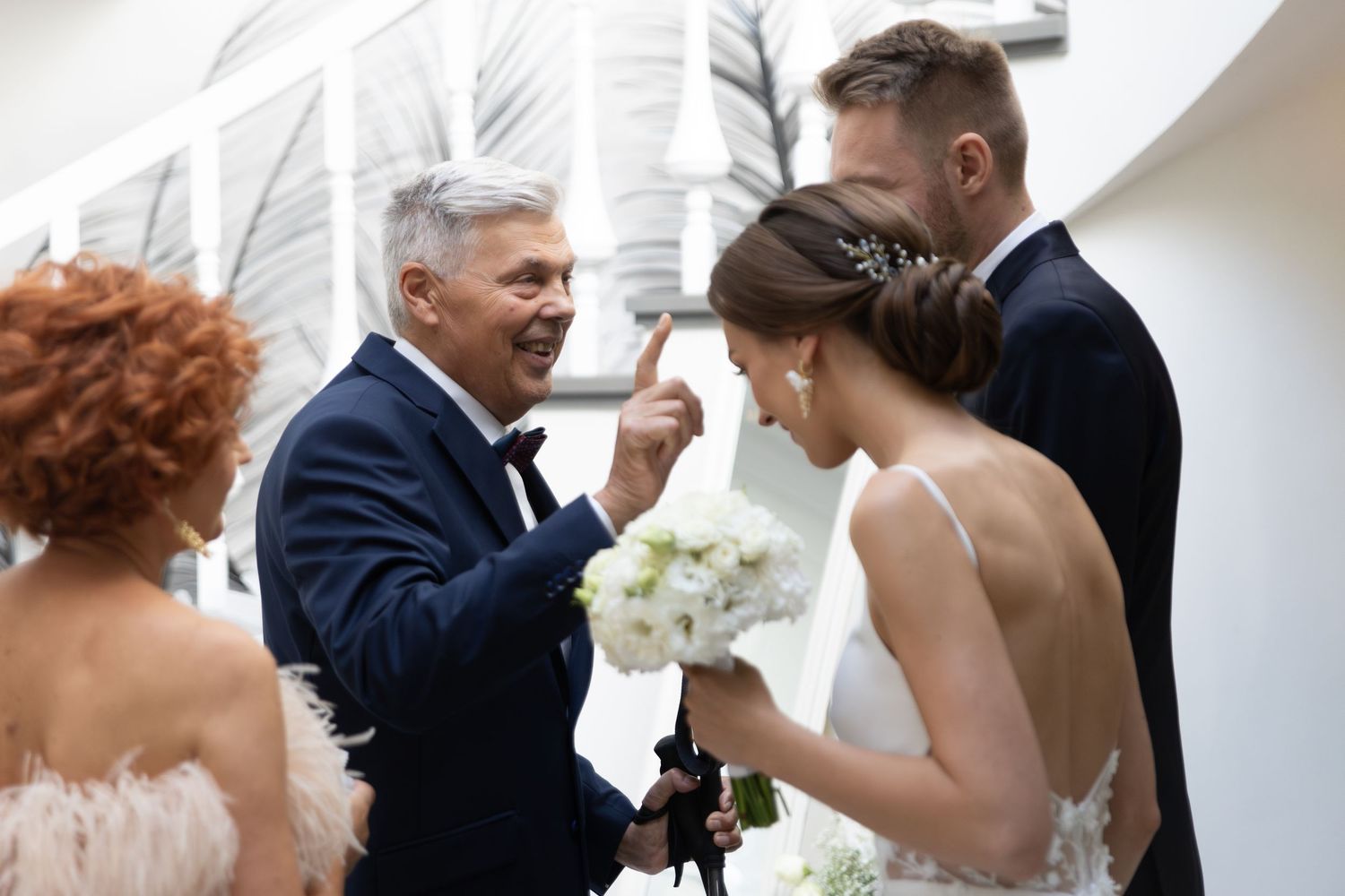 A heartfelt moment at a wedding ceremony with a bride holding white flowers and guests gathered around.