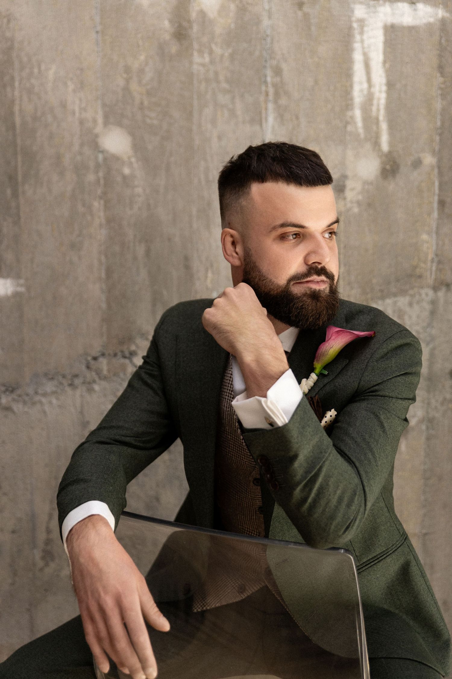 Professional studio portrait series of a fashionable man in green blazer and white shirt posing against concrete wall.