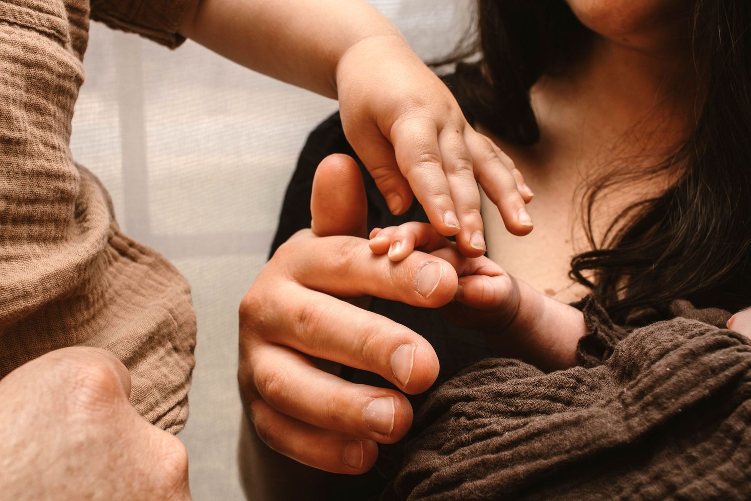 Close-up shot of hands gently touching and interacting in warm lighting.