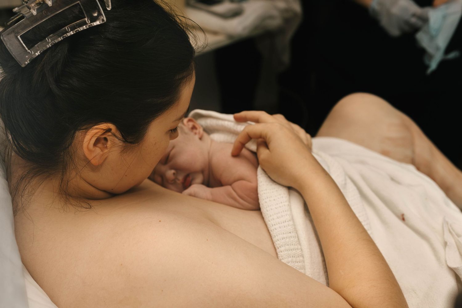 mother holds baby after birth birth photography