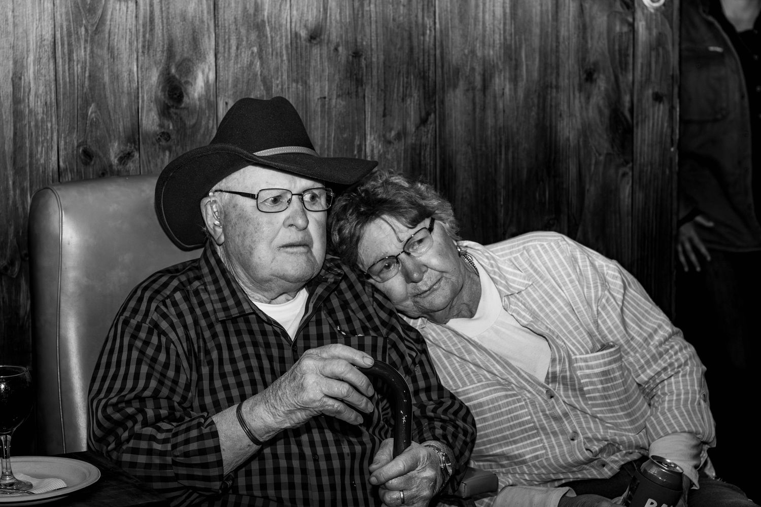 A tender moment of rest and companionship in a rustic western-themed setting.