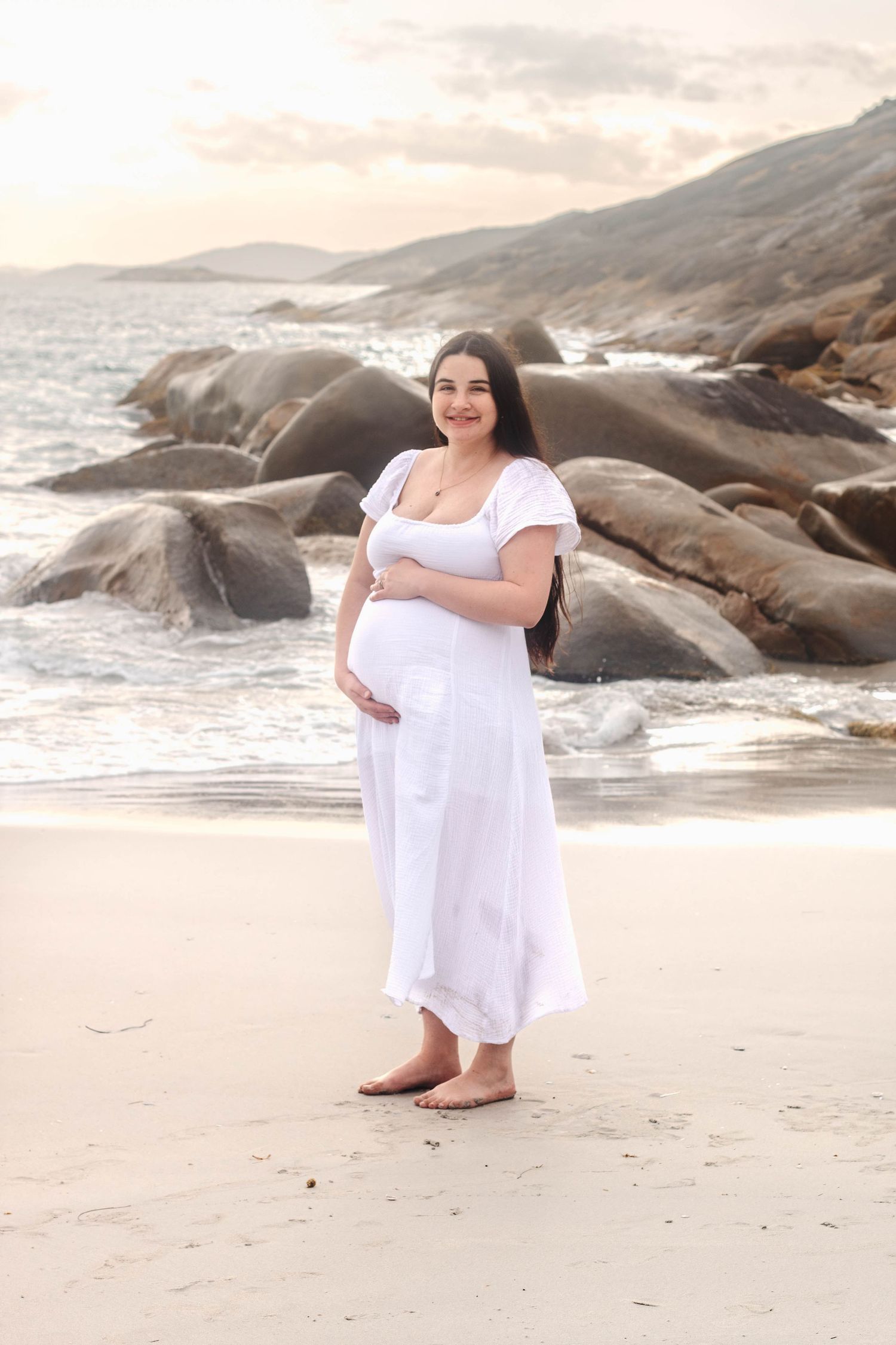 Elegant beachside photography session with soft lighting and natural coastal elements.