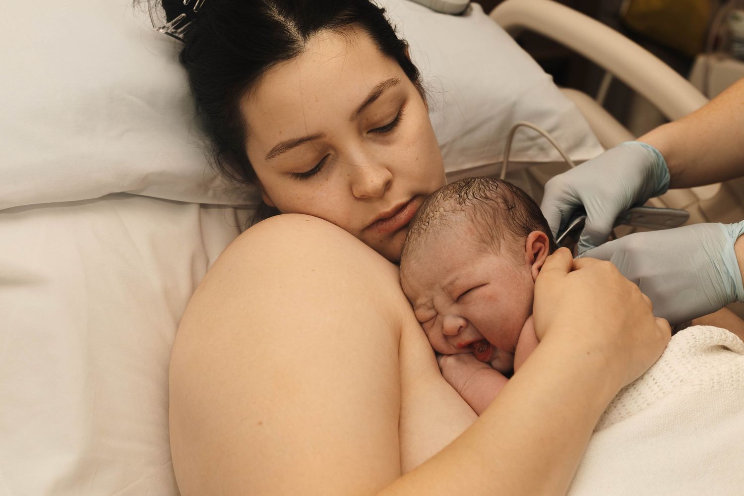 mother holds baby after birth birth photography