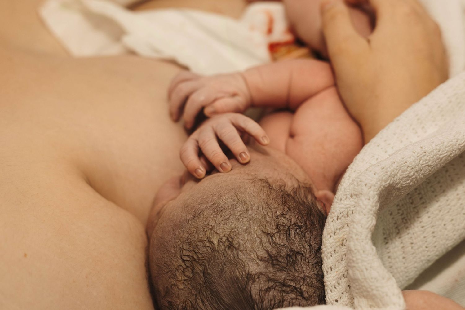 mother holds baby after birth birth photography