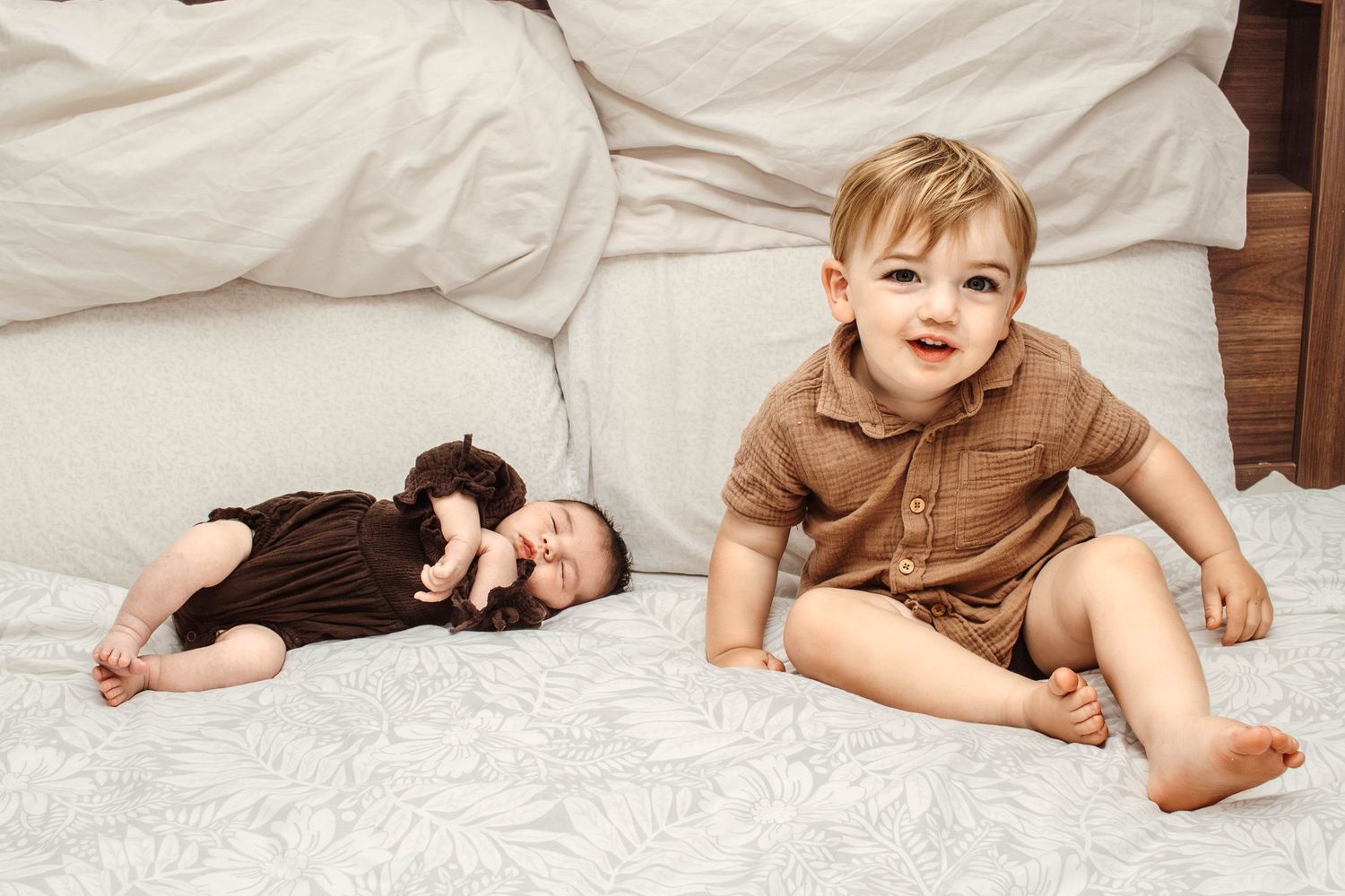 Candid shot of two people relaxing on white bedding.