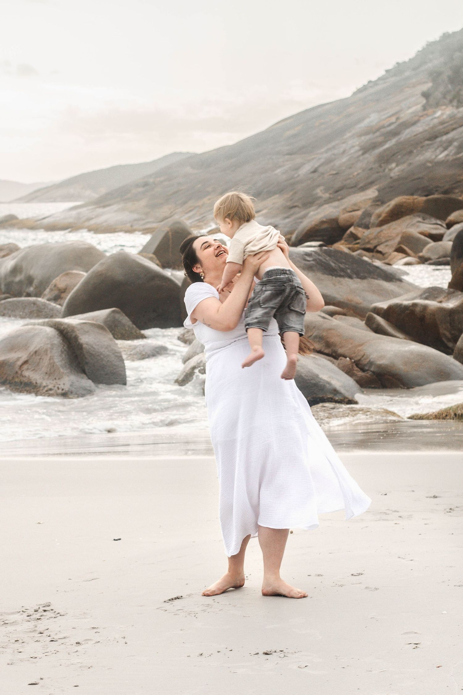 Artistic dance movements photographed against a dramatic coastal landscape at dusk.