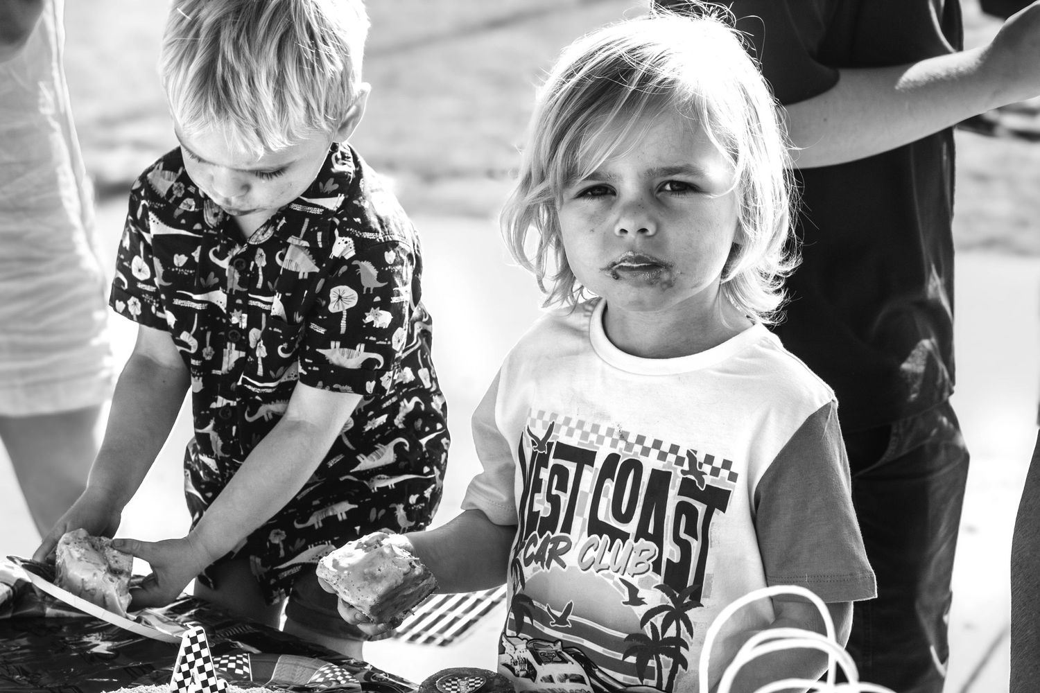 A black and white collage of children in casual clothing showing various playful and candid moments.