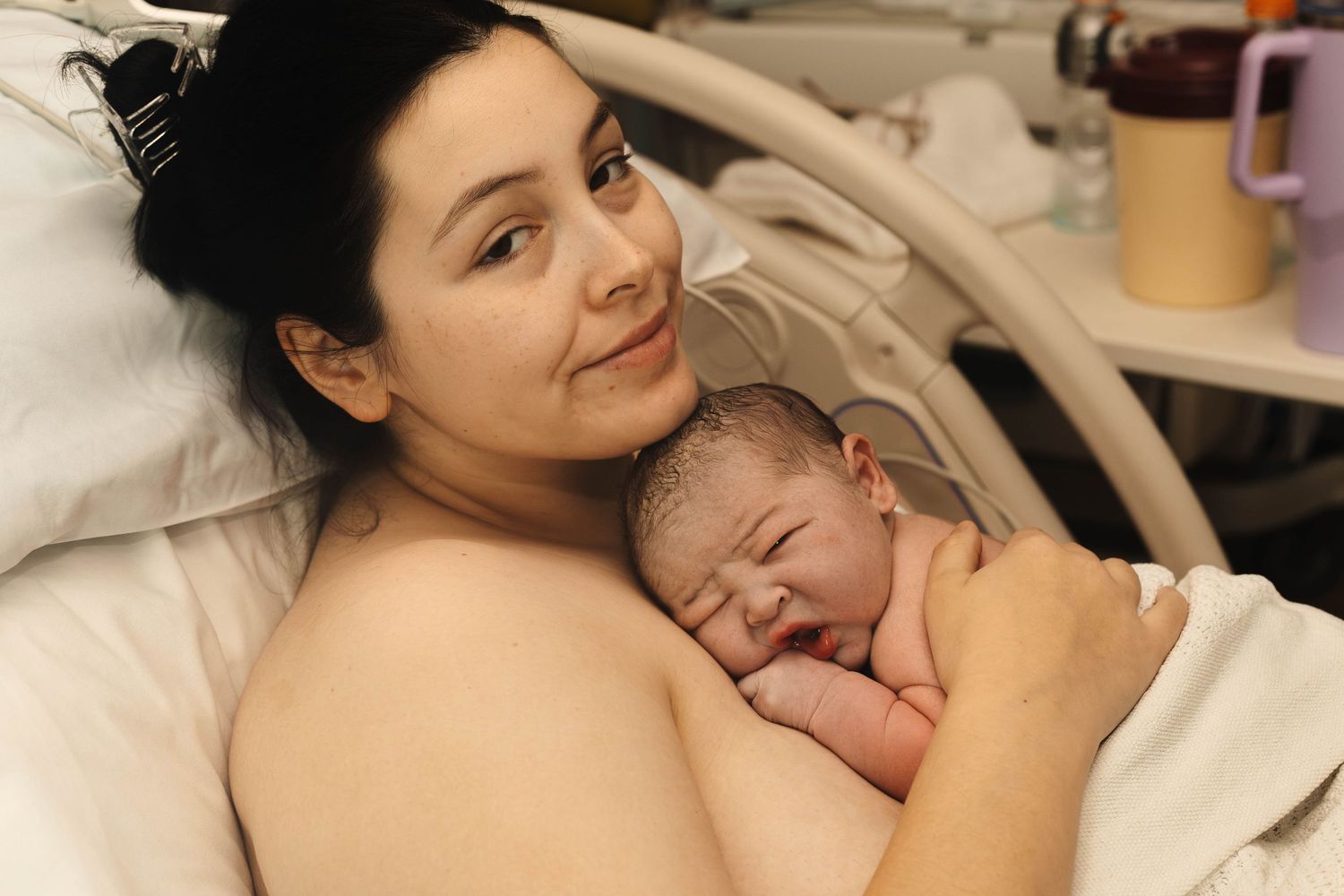 mother holds baby after birth birth photography