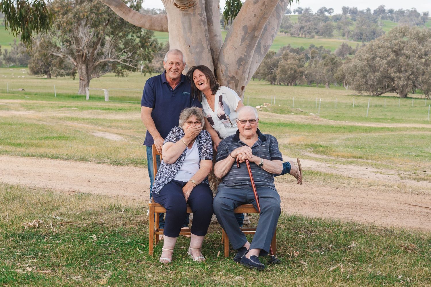 Beautiful family portrait under eucalyptus tree in Australian countryside setting.