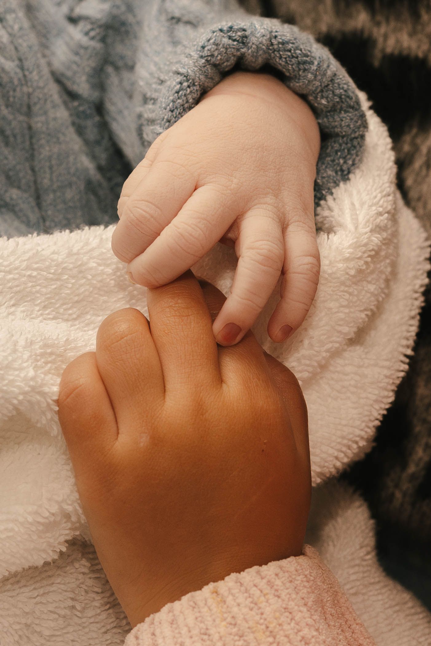 newborn holding toddler siblings hand birth photography